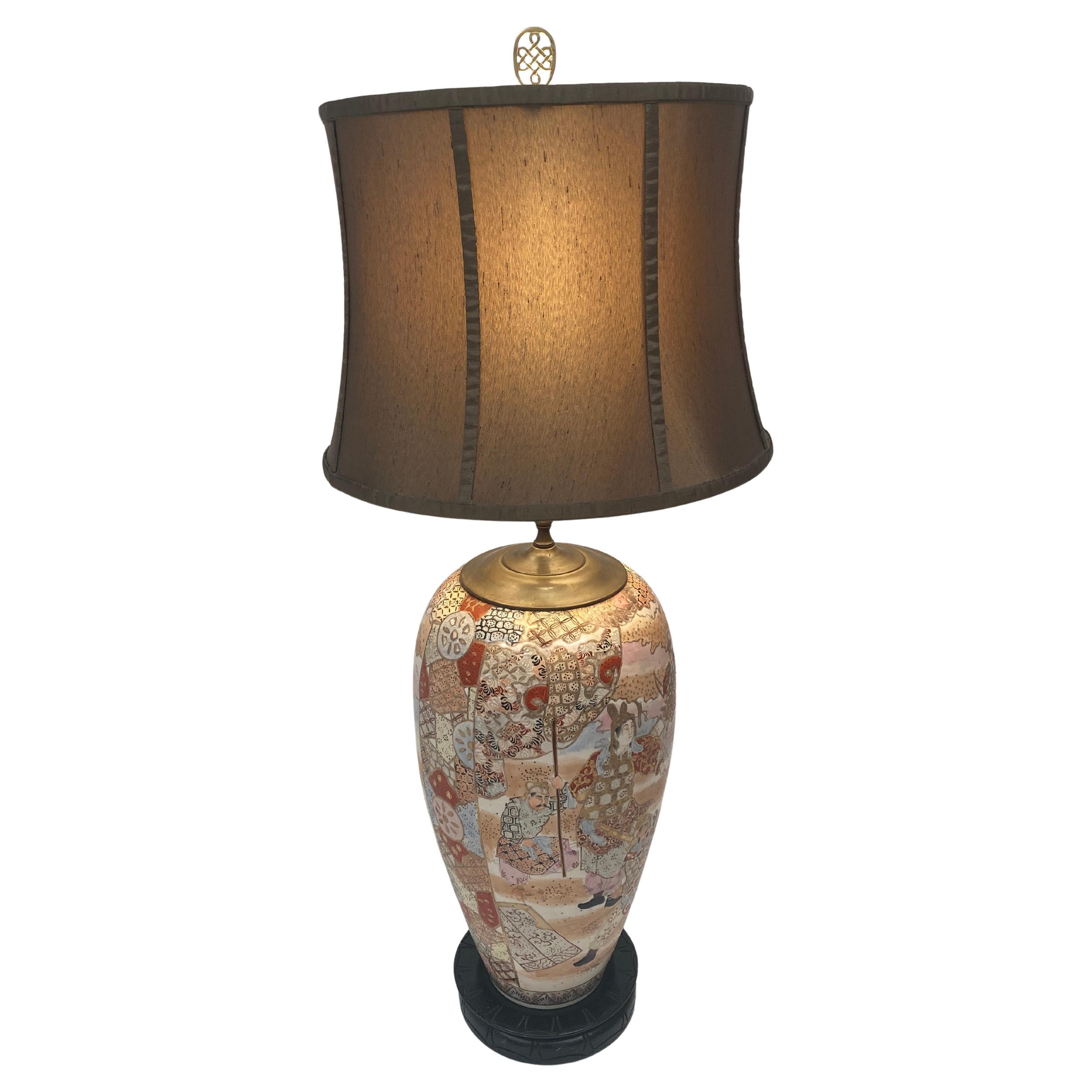 This mid 19th century Japanese Meiji Period Kyo Satsuma Vase Lamp is a truly phenomenal piece of art. With multiple scenes that include Japanese figures in ceremonial costumes in various countryside environments, this very large lamp will add depth