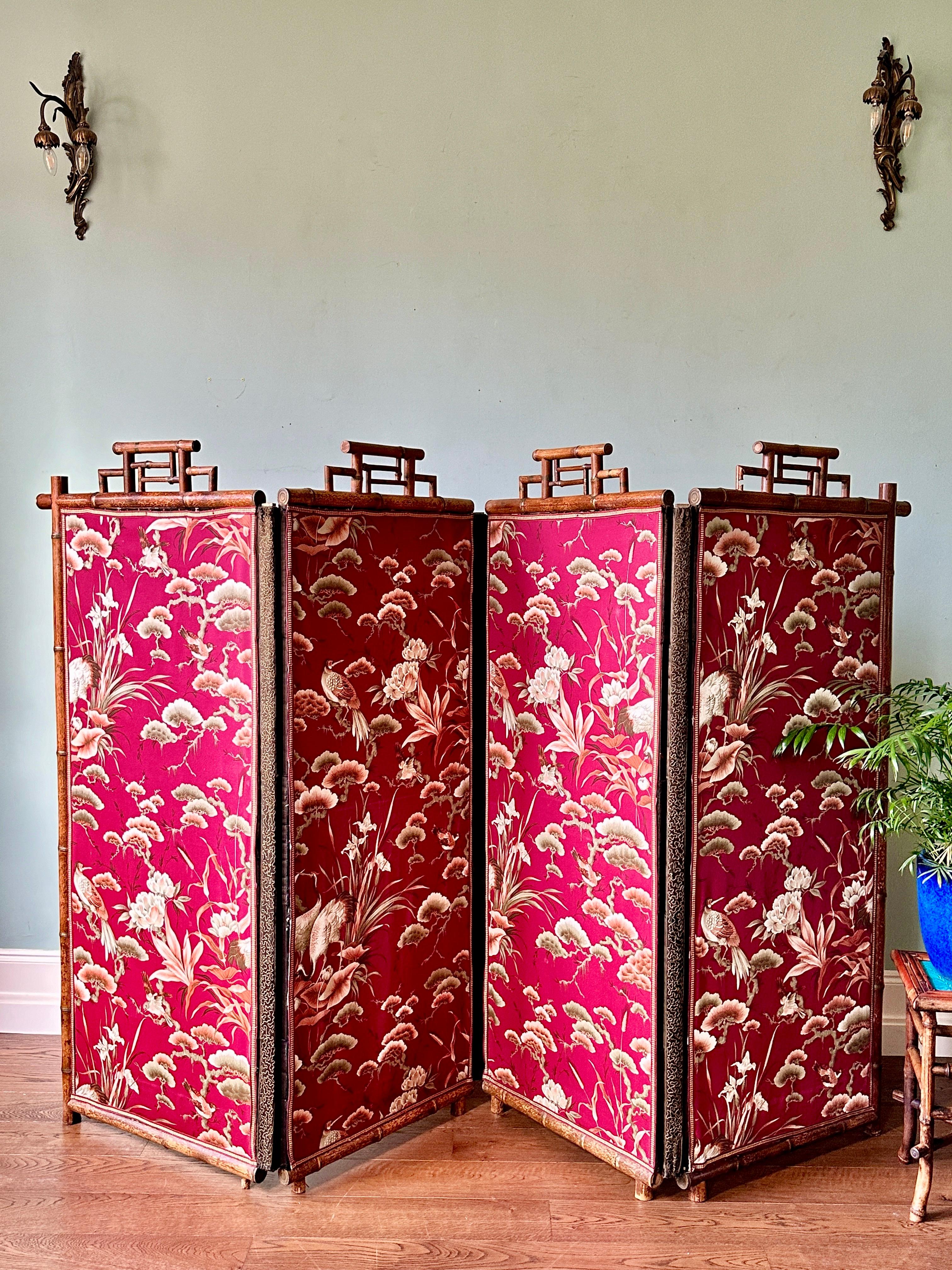 Large C19th Japanese silk and bamboo screen.

A truly superb four-fold room divider with silk panels depicting a forest scene with birds and flowers. Each panel features a bamboo crown with faded gilt details, embroidered edging and decorative,