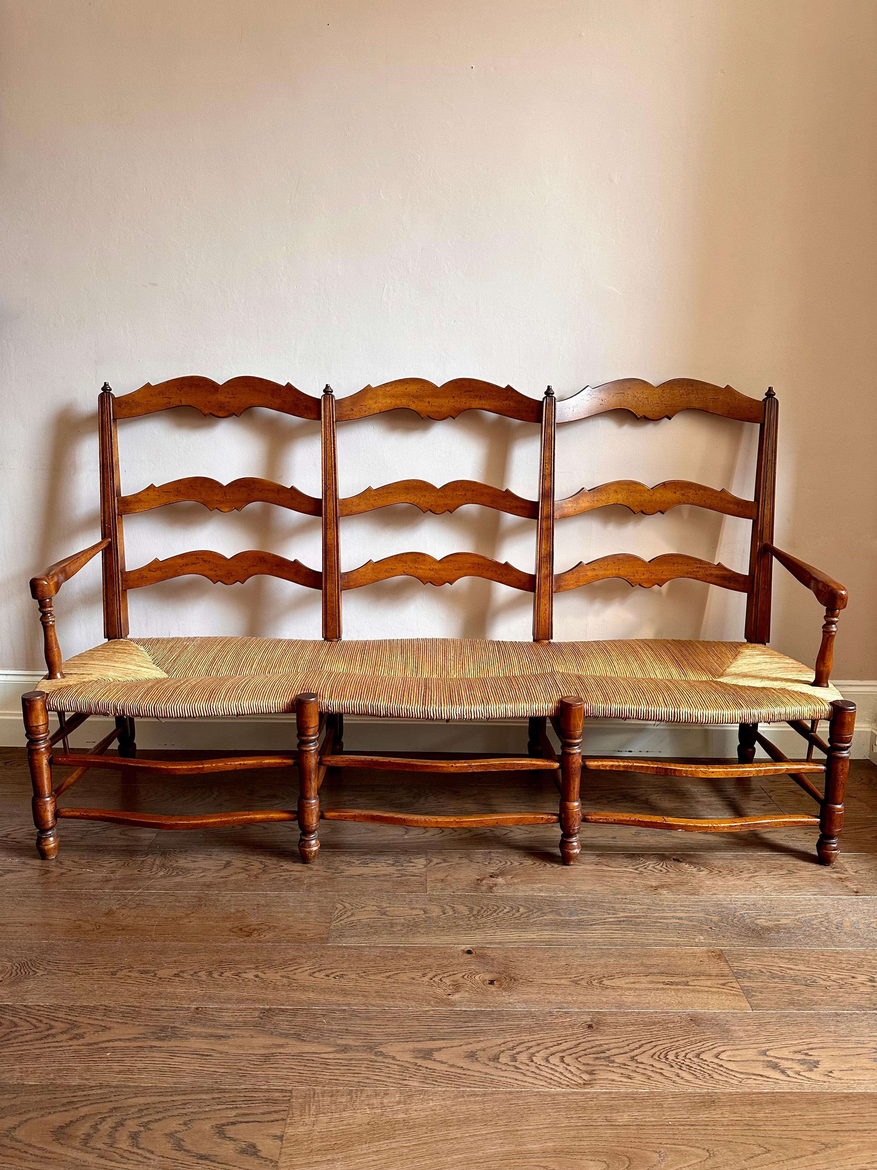 Large C19th Provencal cherry wood rush seat bench.

Beautiful French settle in a deep, warm finish with wonderfully smooth aged patina. In excellent, solid condition with minor and attractive wear. 

Length 180cm Depth 63cm Back Height 101cm Seat