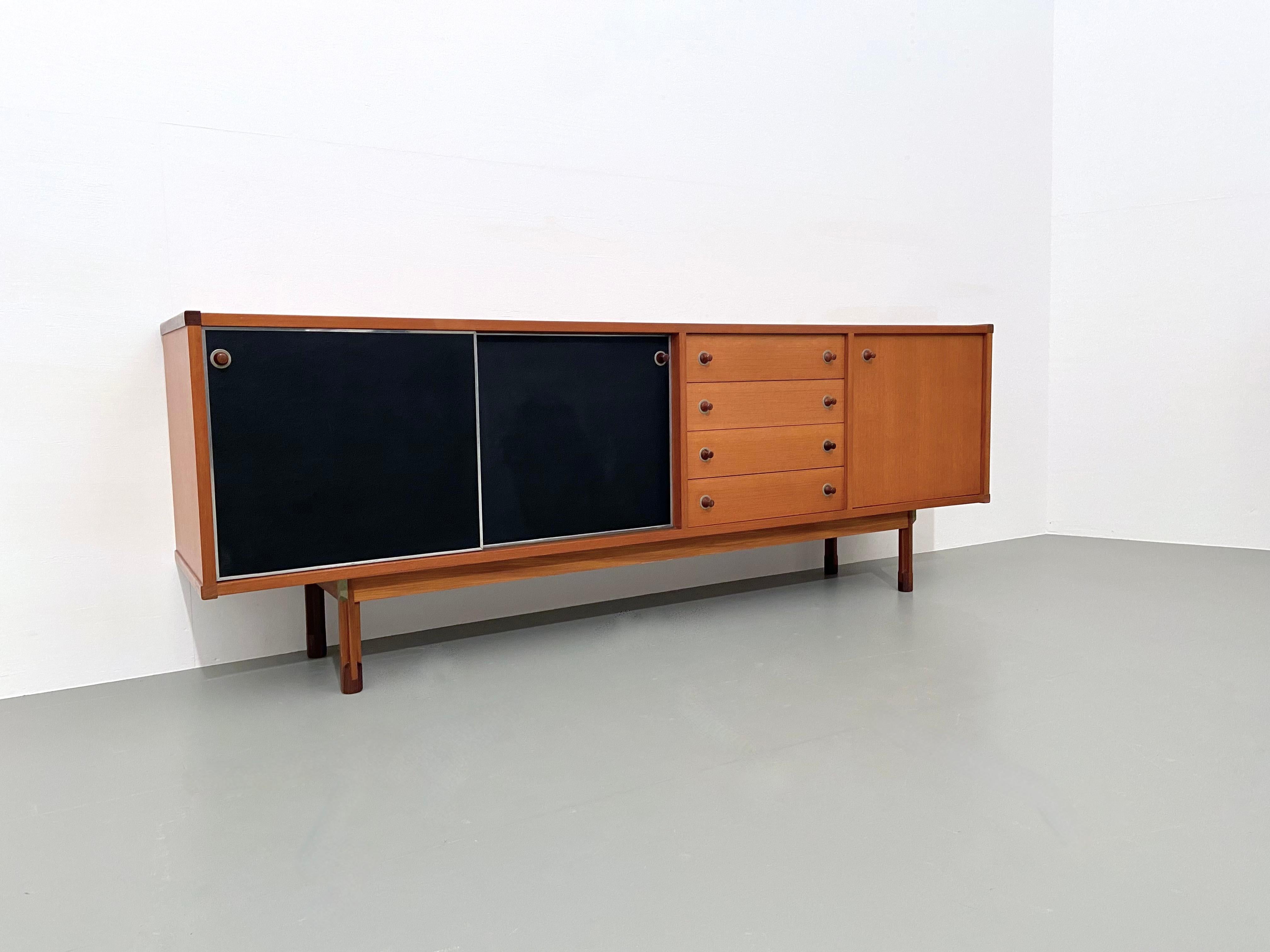 What stands out are the black laminate panels that work very well with the warm teak that is in great condition. A very nice credenza with two sliding doors to cover a larger shelve, four drawers that run very smooth and a smaller storage space with