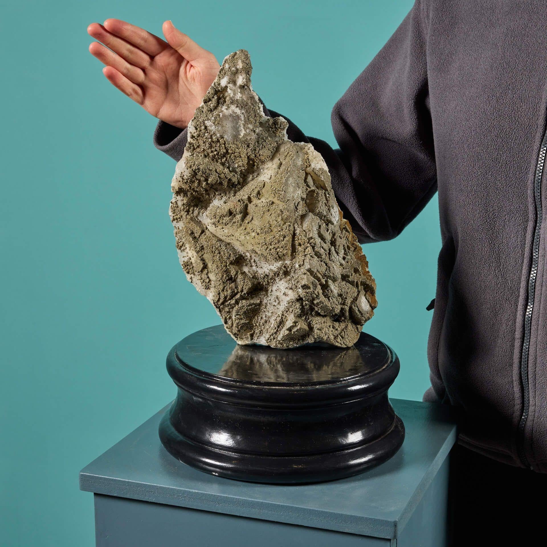 A very large cabinet pyrite and calcite specimen originating from Madagascar, displayed on one of our exclusive museum-quality painted plaster bases.

Naturally formed over millions of years, this striking mineral specimen has a calcite base with a