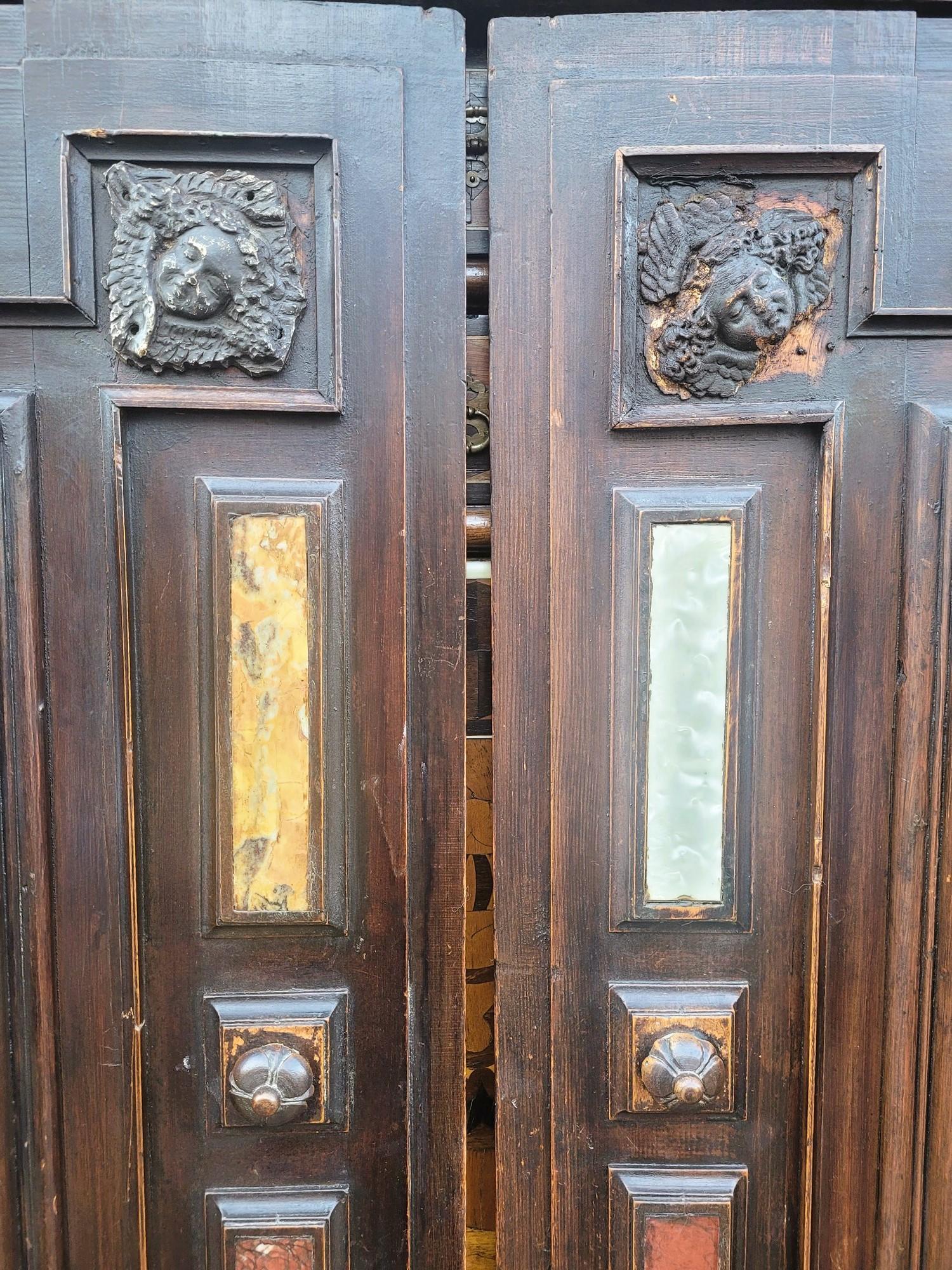 Large cabinet on its base, opening on the front with 2 large doors decorated with marble slabs, and revealing a series of 18 drawers and a central door
The drawer fronts are in marquetry of different types of wood and mother-of-pearl; the door is