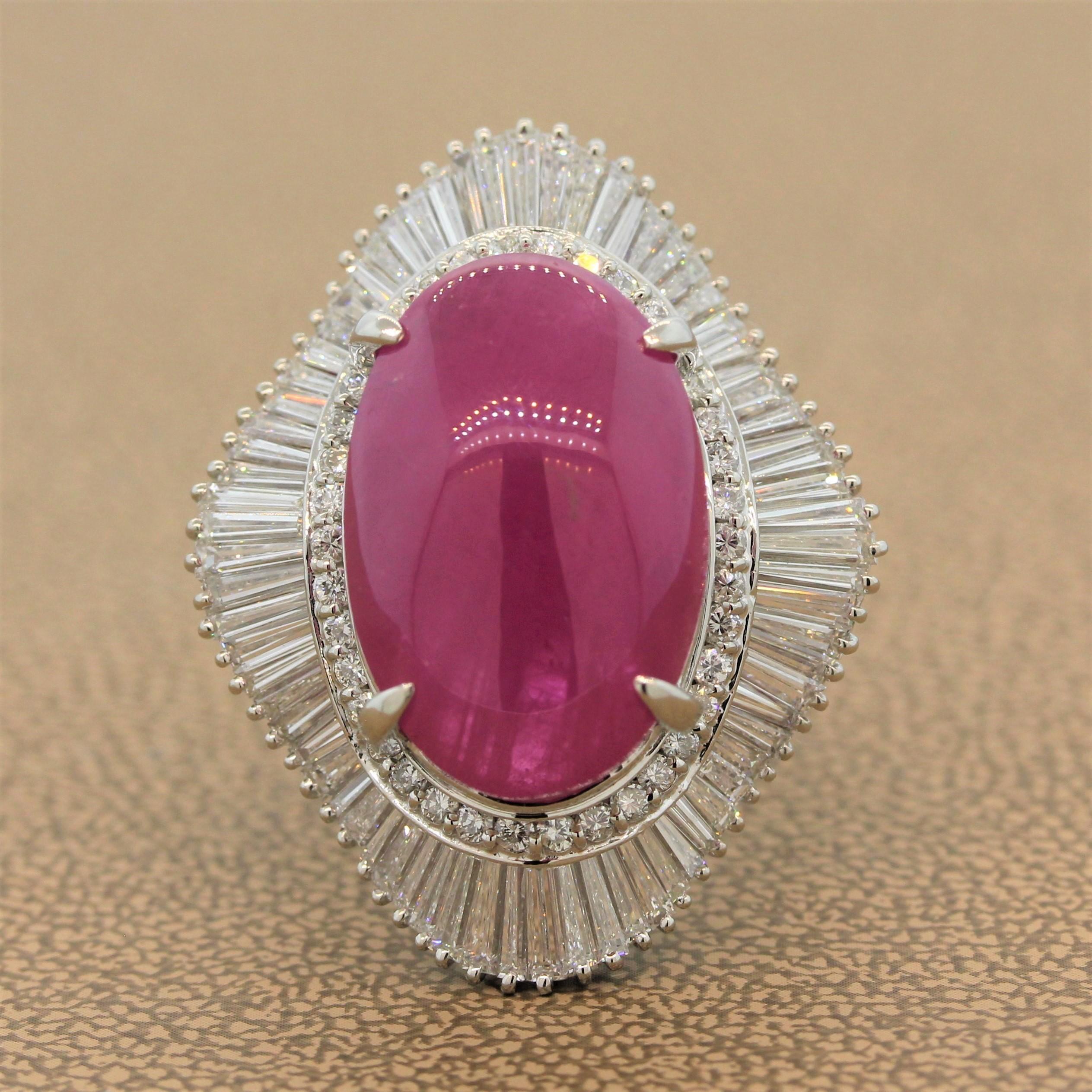 A remarkable gem-set ring featuring a 28.66 carat ruby in a platinum setting. The elongated oval cabochon ruby is surrounded by a double halo of 2.86 carats of diamonds. The round and baguette cut diamonds are set in a flared design for this