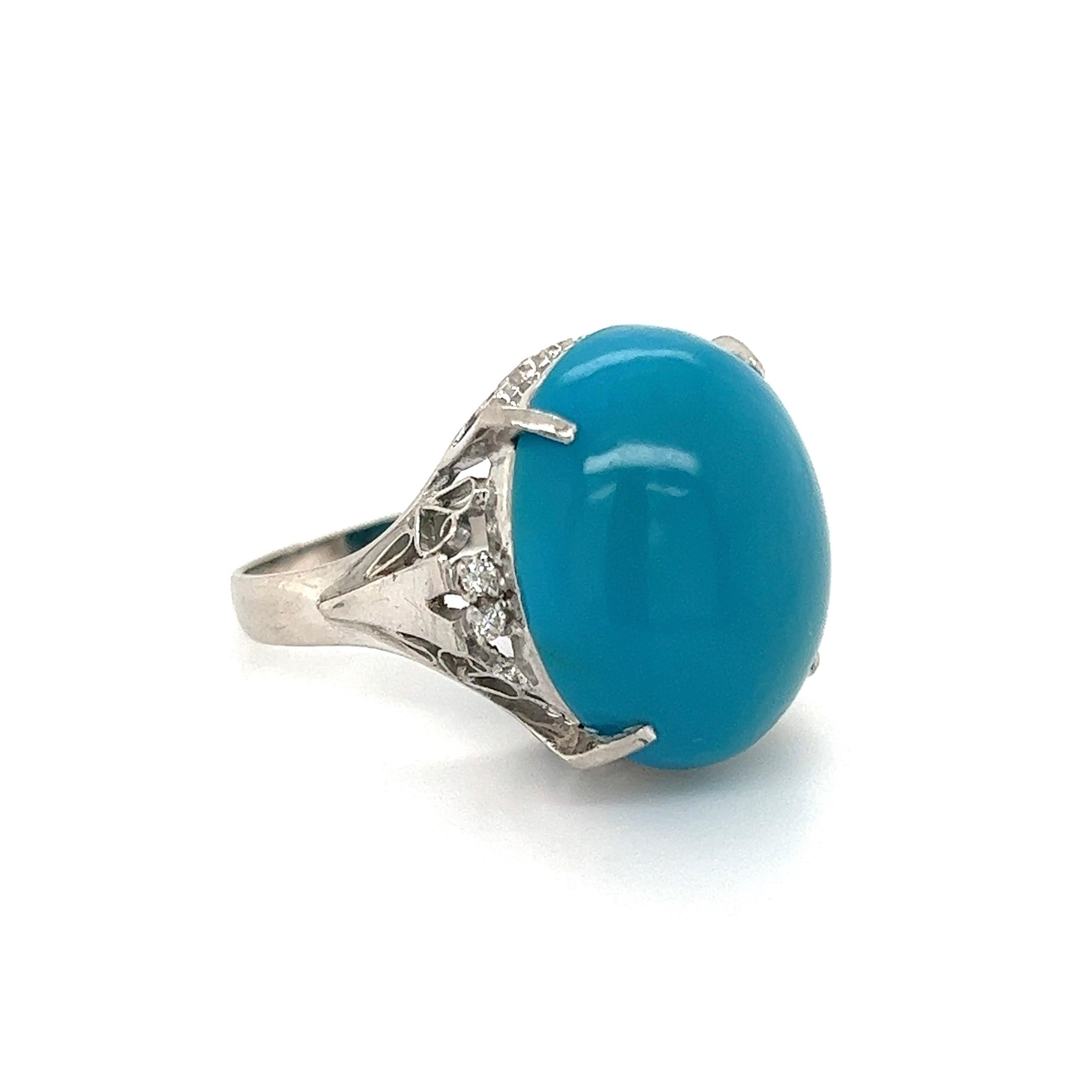 Simply Beautiful! Turquoise and Diamond Platinum Ring, securely centered by a Large Oval Cabochon Turquoise. Either side set with Diamonds, approx. 0.08tcw. Finely Hand crafted Platinum mounting. Approx. Dimensions: 1.26” l x 0.78” w x 0.78” h. Ring