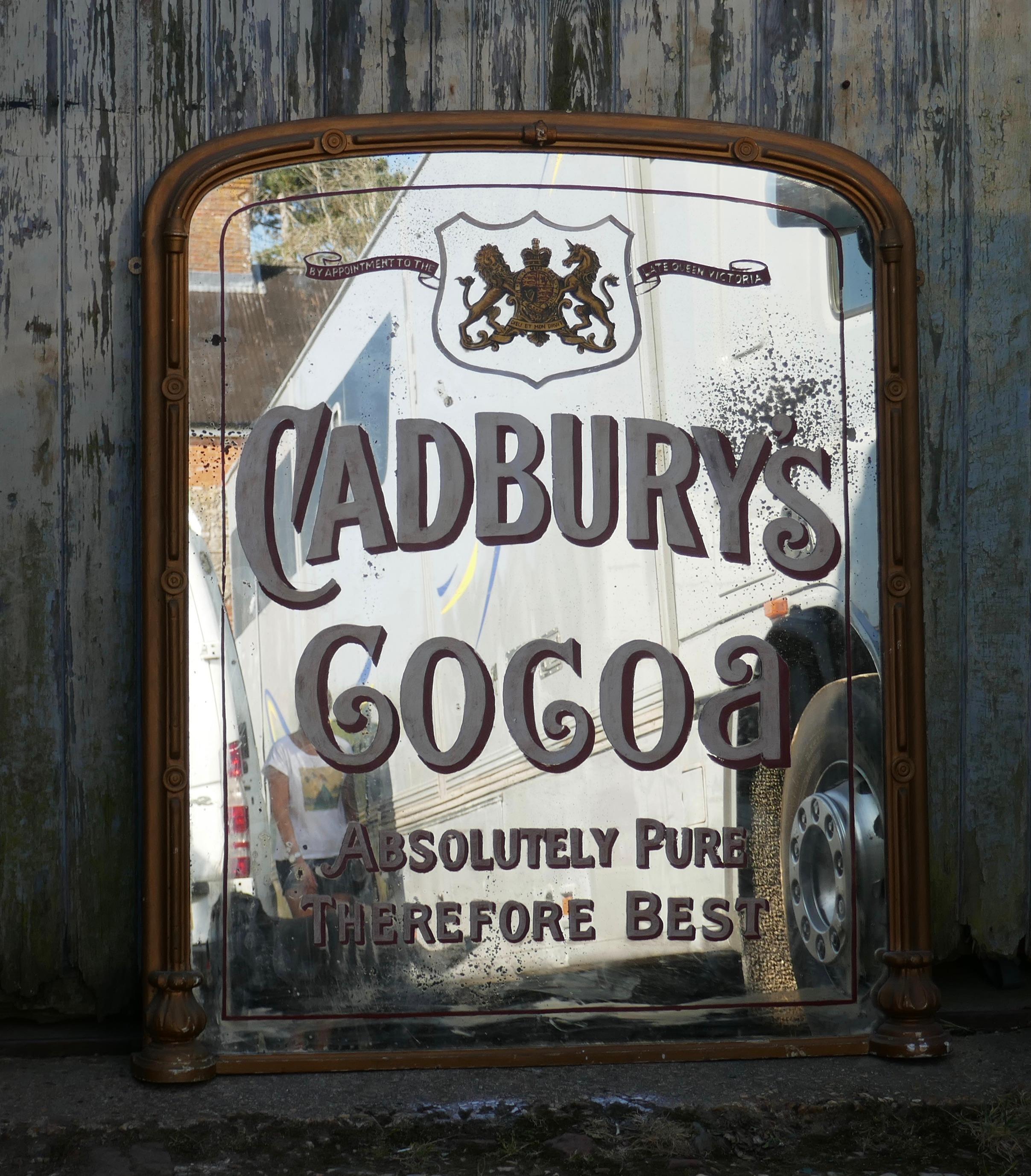 Large Cadbury coca shop advertising wall mirror, with royal appointment

The mirror has painted white and red shadowed lettering, it has a plain D-shaped 3” wide gilt overmantel style frame

The looking glass is in fair condition with some