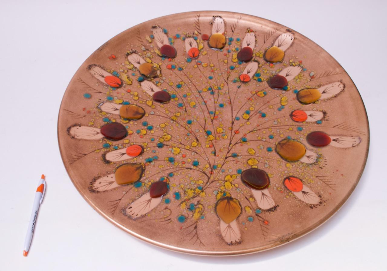 Impressive and large California Cloisonné enamel on copper charger made by Landau Goldsmith of Los Angeles with floral / petal motif throughout. Attractive color combinations. The honey, amber, and orange circles within the pattern have a jewel-like