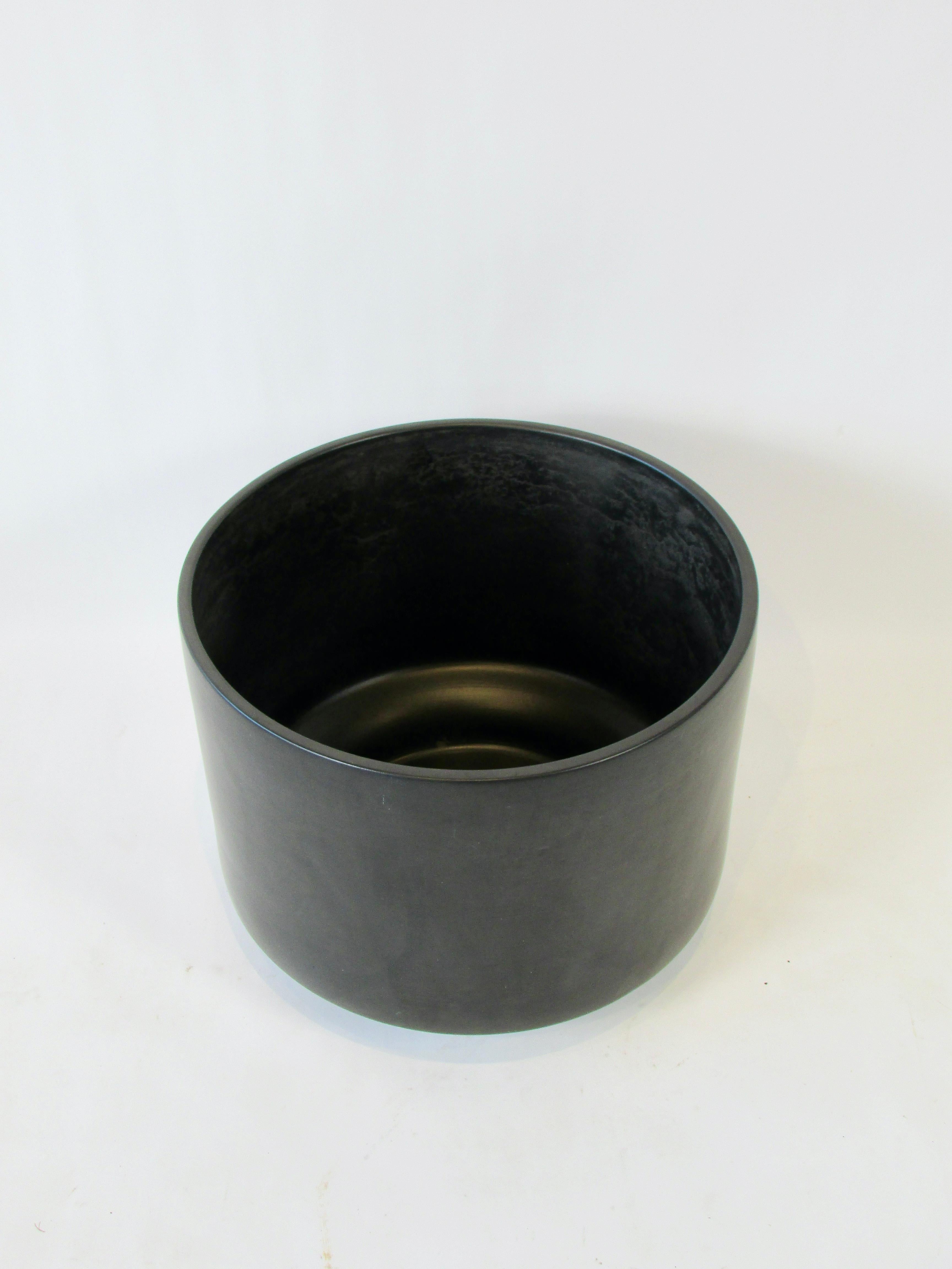 Large Gainey of Laverne California planter pot. Finished in a matte black glaze. No cracks or chips no drill through. Very clean exterior. Evidence of use shows on interior side walls.