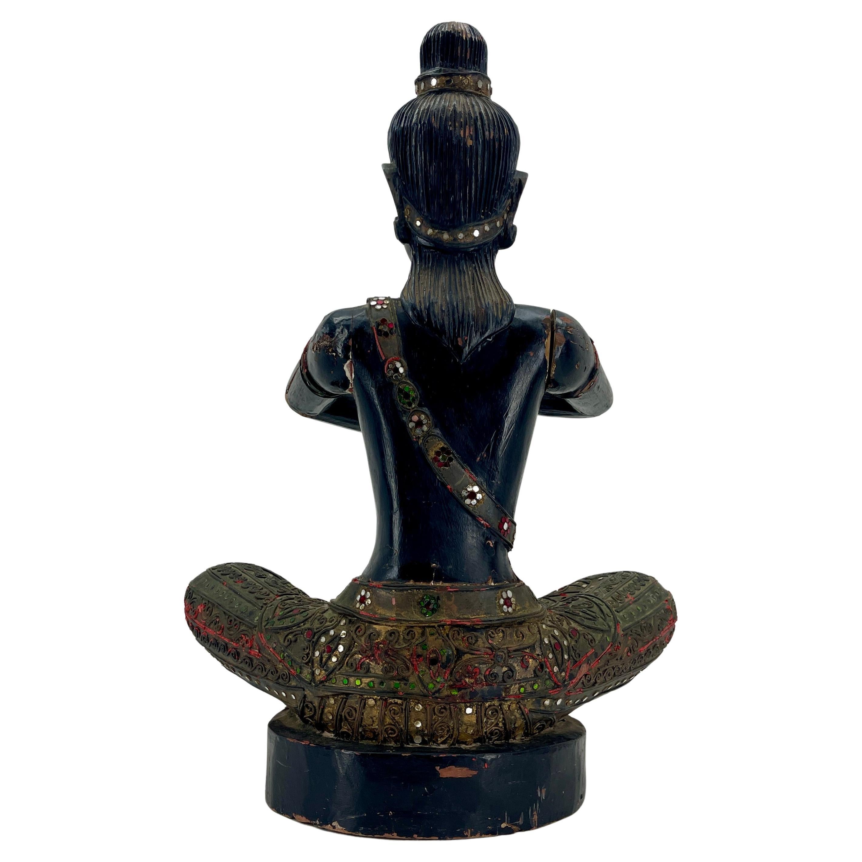Sitting black painted sitting Buddha sculpture, Cambodian, circa 1920s
The statue is decorated with multiple red and green colored mirrored glass pieces. Several area around the chest was original gilded.