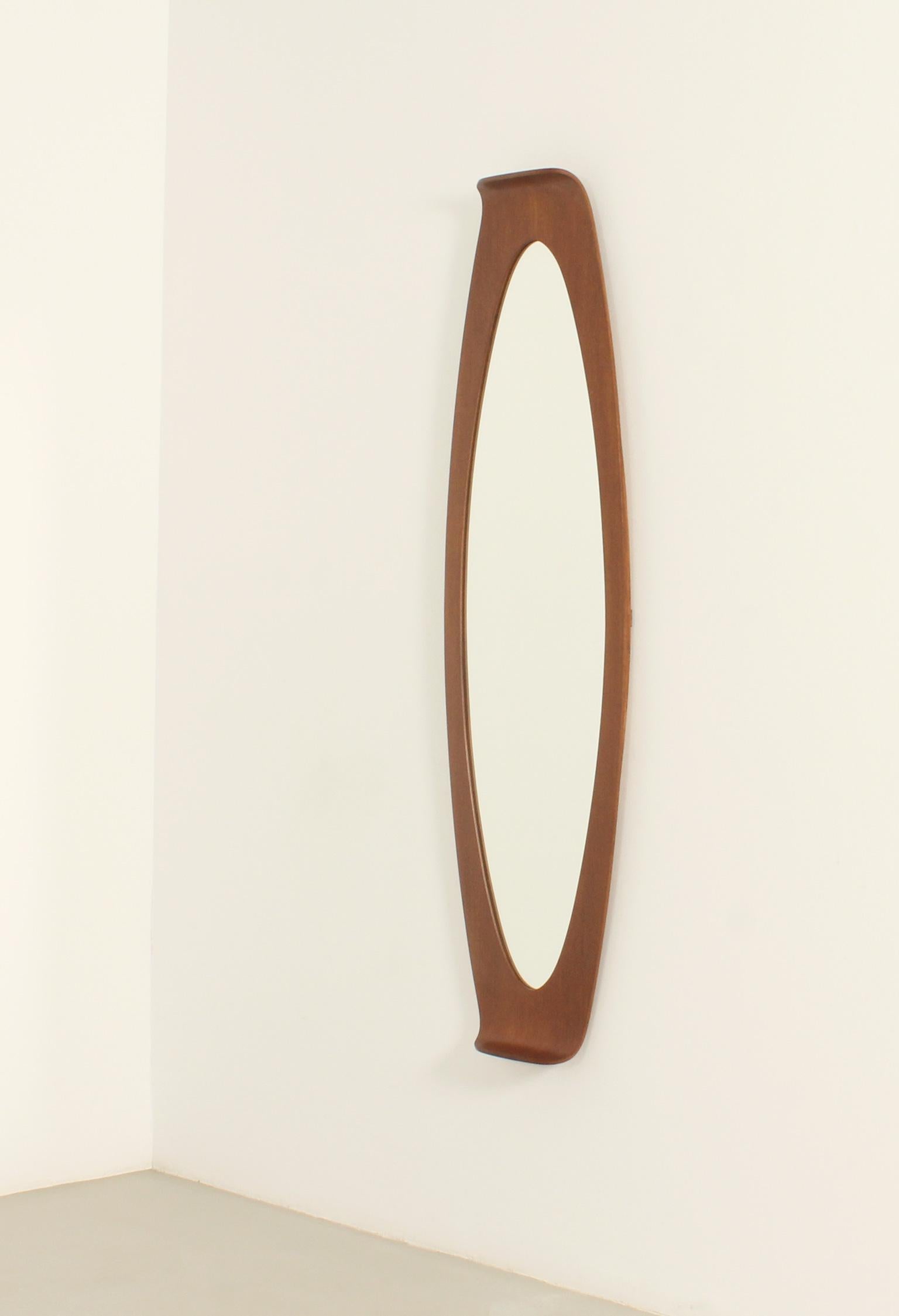 Large wall mirror by Franco Campo and Carlo Graffi for Home, Italy, 1950's. Curved teak wood frame with mirror. 