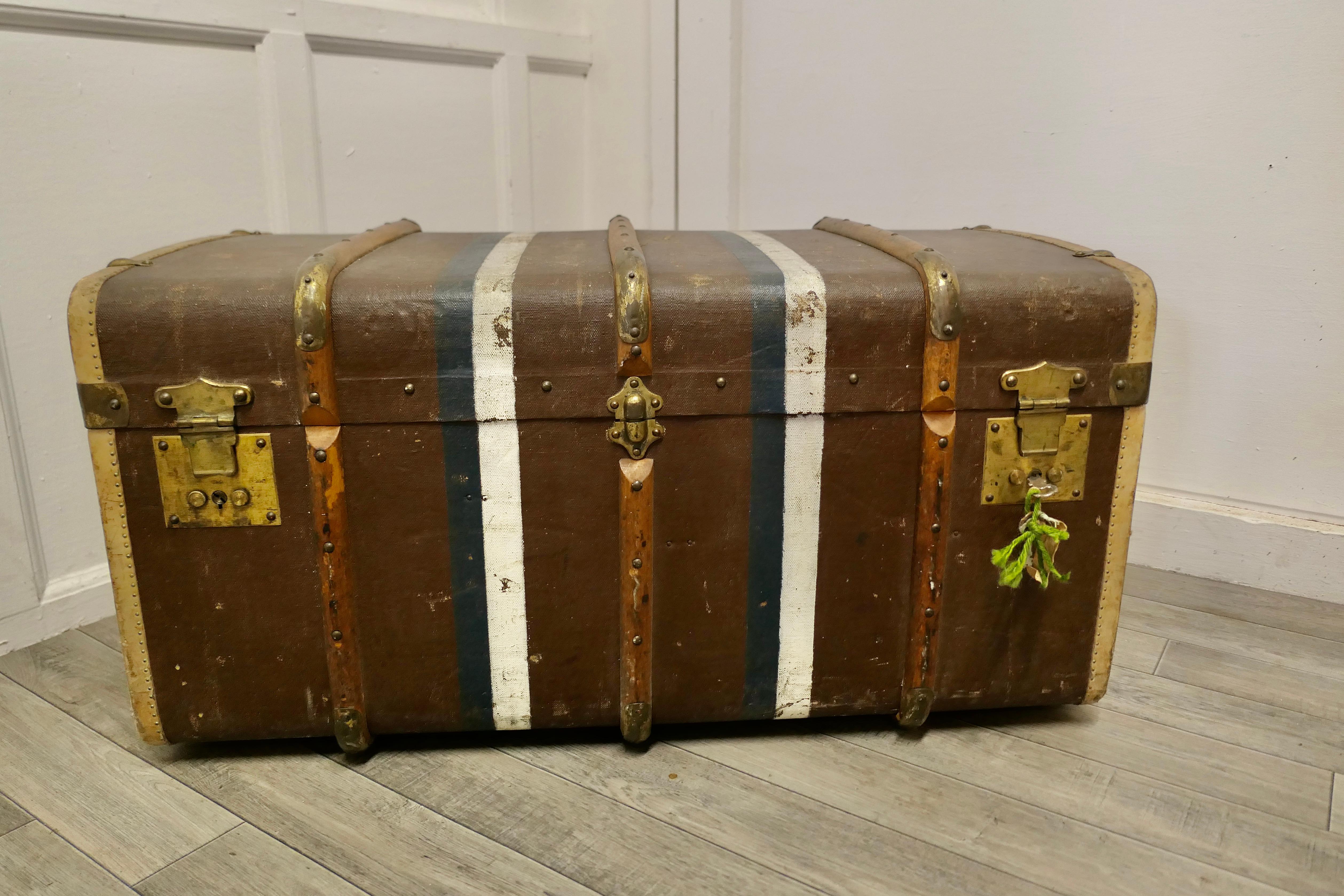 Large Canadian canvas, wood and brass bound steamer trunk.

This is a very top quality 19th century travel trunk, it is covered in canvas, it has wooden and brass banding, on the sides there are leather carrying handles and on the front 3 brass