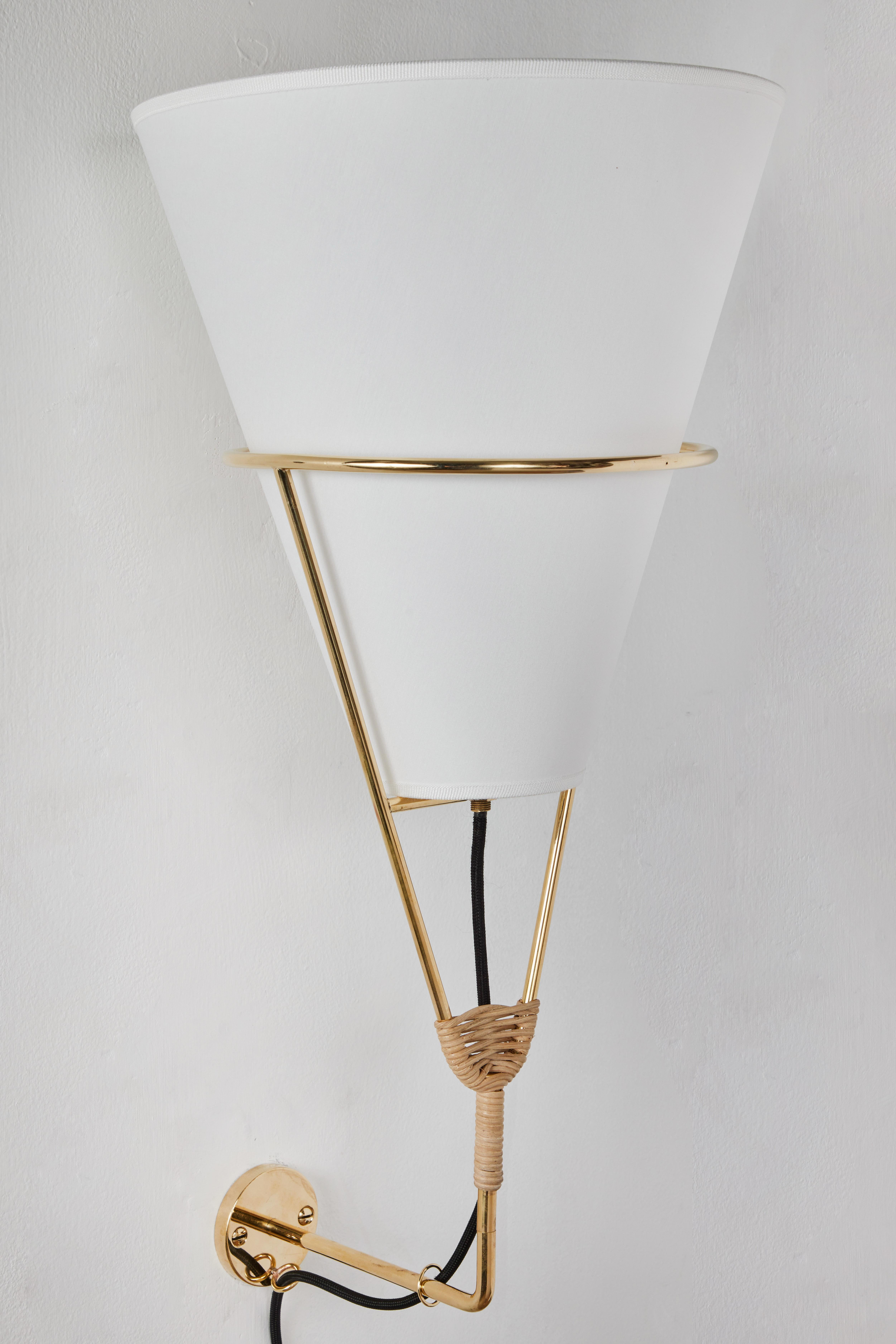 Large Carl Auböck 'Vice Versa' wall lamp. A newly designed variant exclusive to Two Enlighten based on the iconic Vice Versa table and floor lamp series designed by Carl Auböck III in the 1950s. Executed in polished brass and hand woven wicker with
