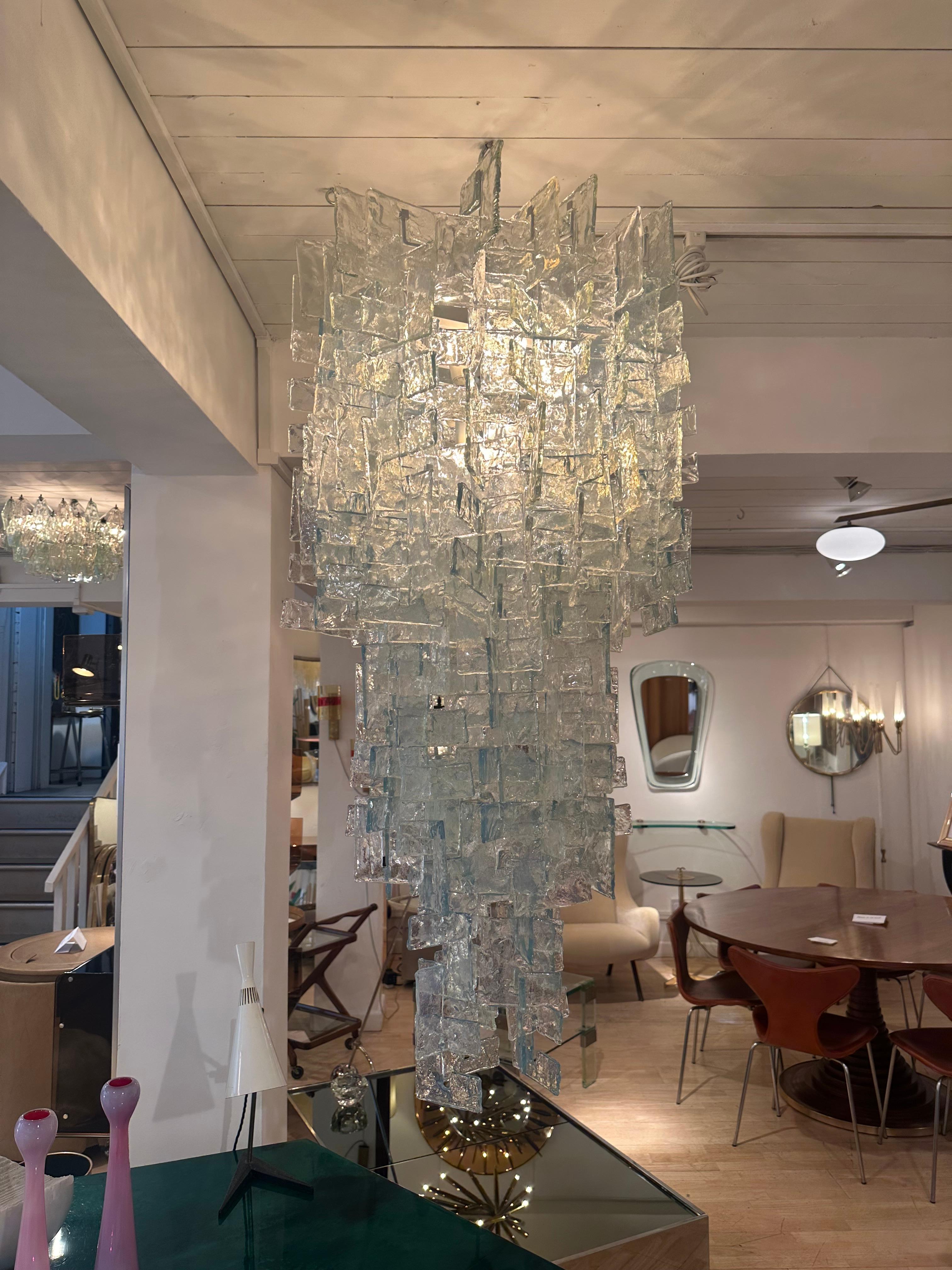 Chandelier by Carlo Nason for Mazzega. Italy c1960

Consists of hundreds of individual interlocking glass 'G' shape. 

The glass is a clear opalescent 