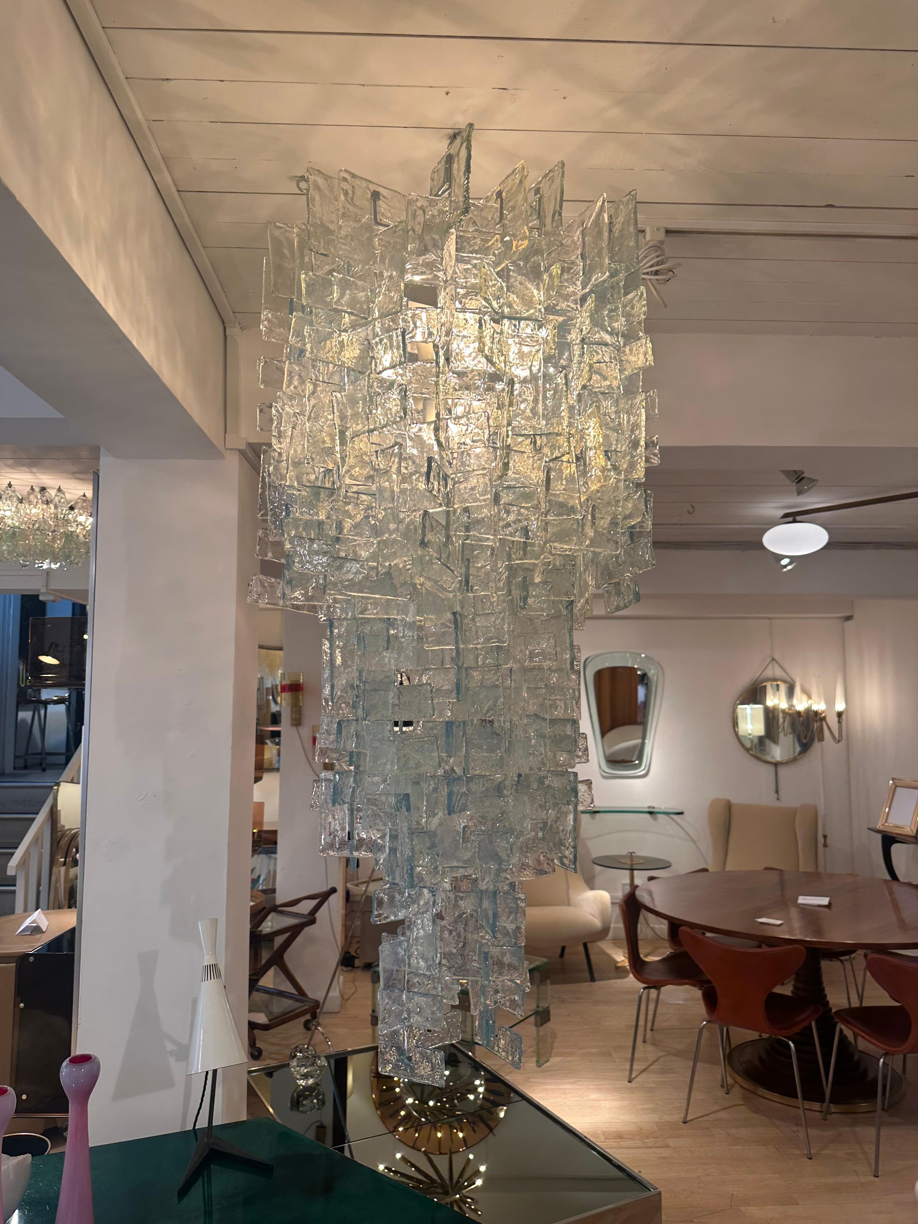 Original Carlo Nason interlocking glass elements for Mazzega c 1970

The drop can be extended. There are around 80 pieces of glass not shown here so the chandelier can be larger than shown.

Original Mazzega labels on some elements

The measurements