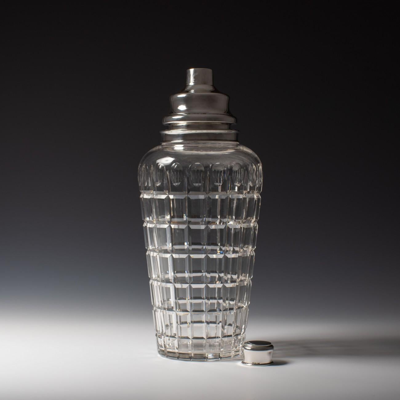 A large stylish Art Deco cut glass cocktail shaker by Cartier with silver top stamped Cartier, Sterling, circa 1940.

Dimensions: 30.5 cm/12 inches (height) x 13 cm/5? inches (max diameter)

Bentleys are Members of LAPADA, the London and Provincial