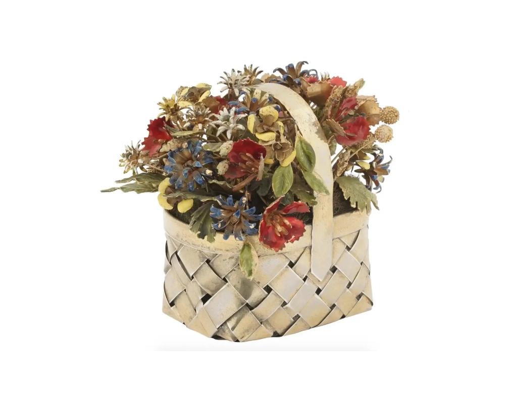 A Cartier hand made gilt sterling silver and enameled figurine. The figurine depicts a basket with flowers designed by Jane Hutcheson. The woven basket with a variety of polychrome decorated flowers. Marked with copyright, Cartier, Hand Made, and a