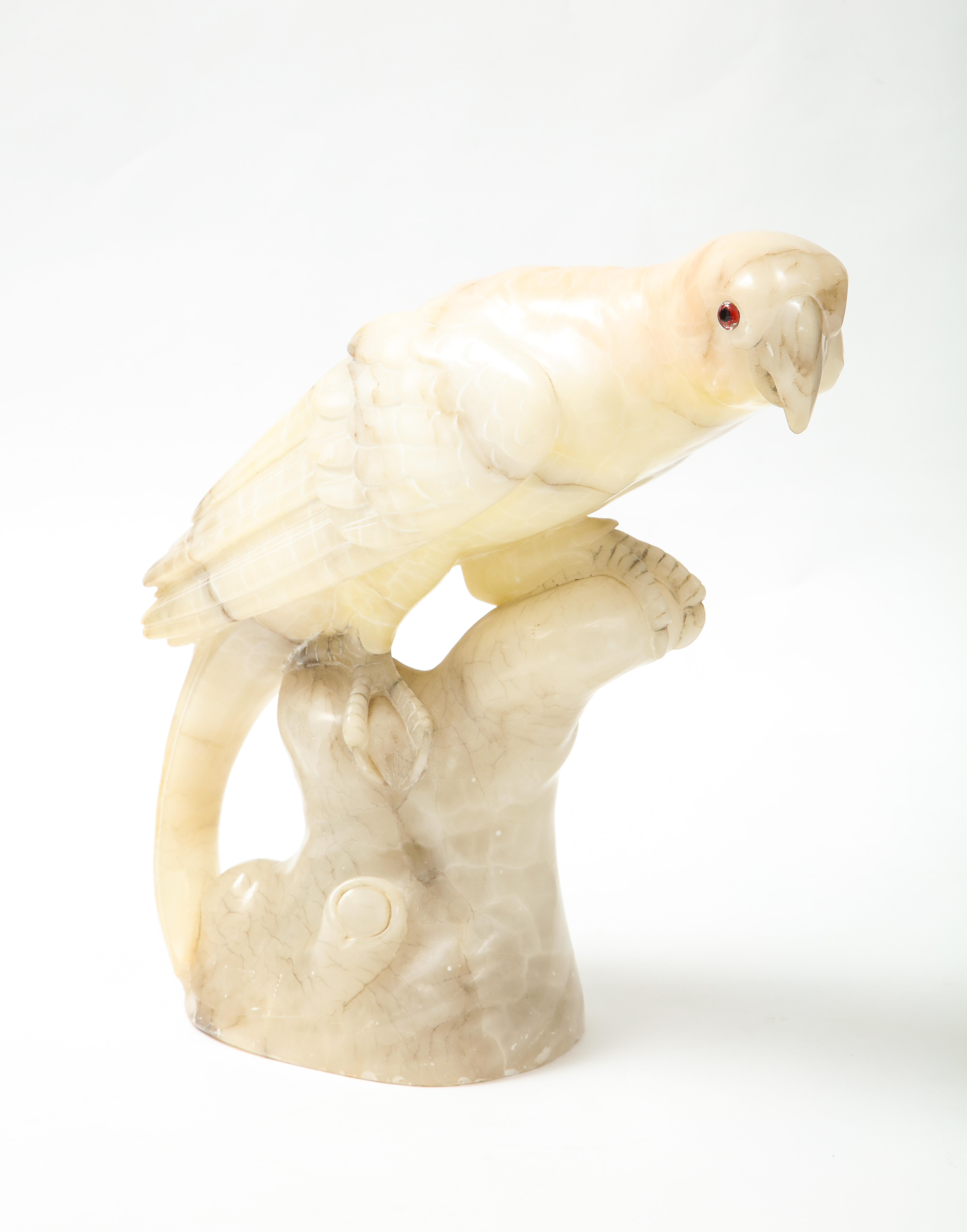 Beautifully carved Alabaster parrot with grey veining and glass eyes.