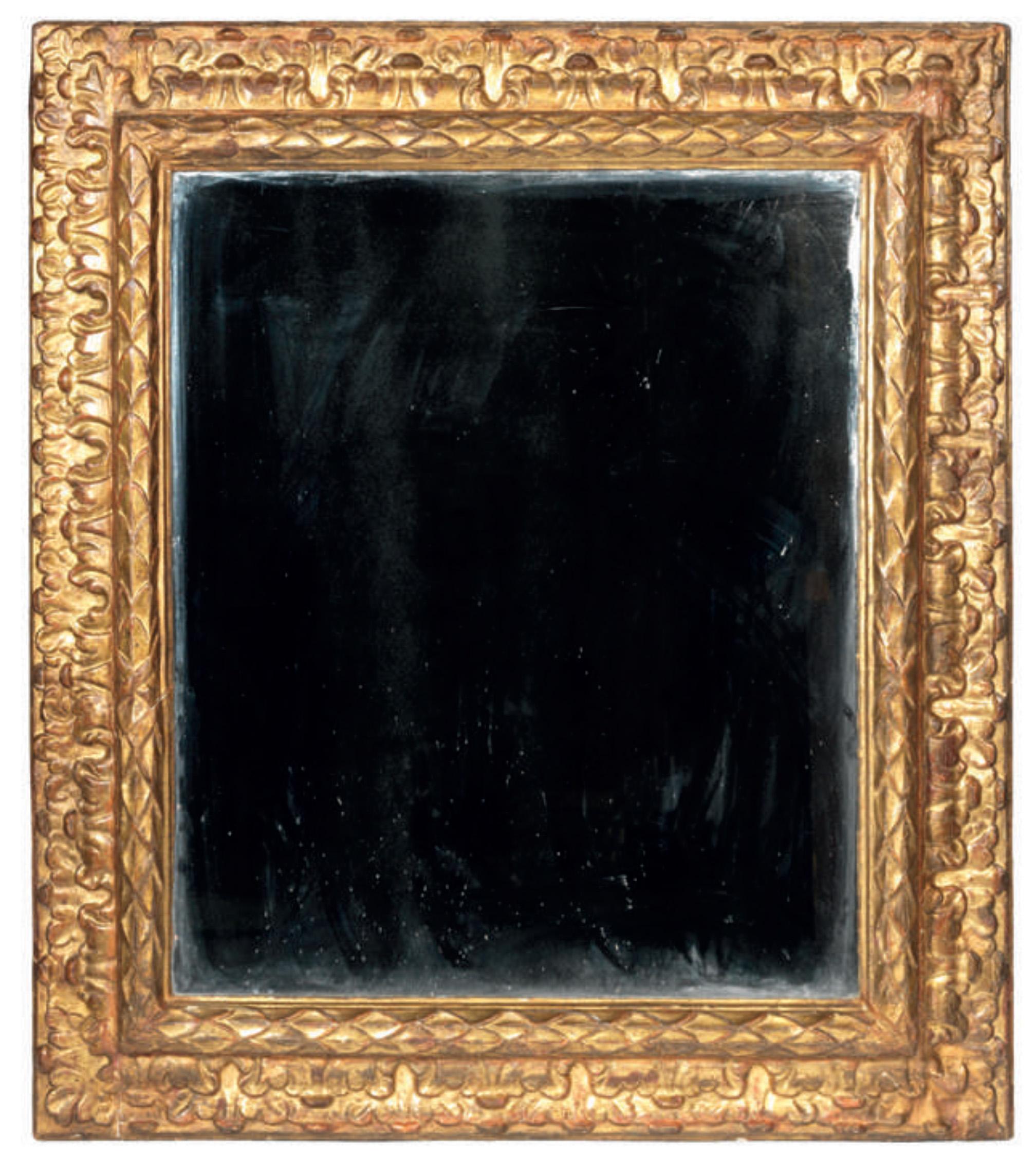 Large carved and gilt wood frame with inverted profile mounted as a miror. The frame is enriched with a laurel leaves and vegetal scroll decor.