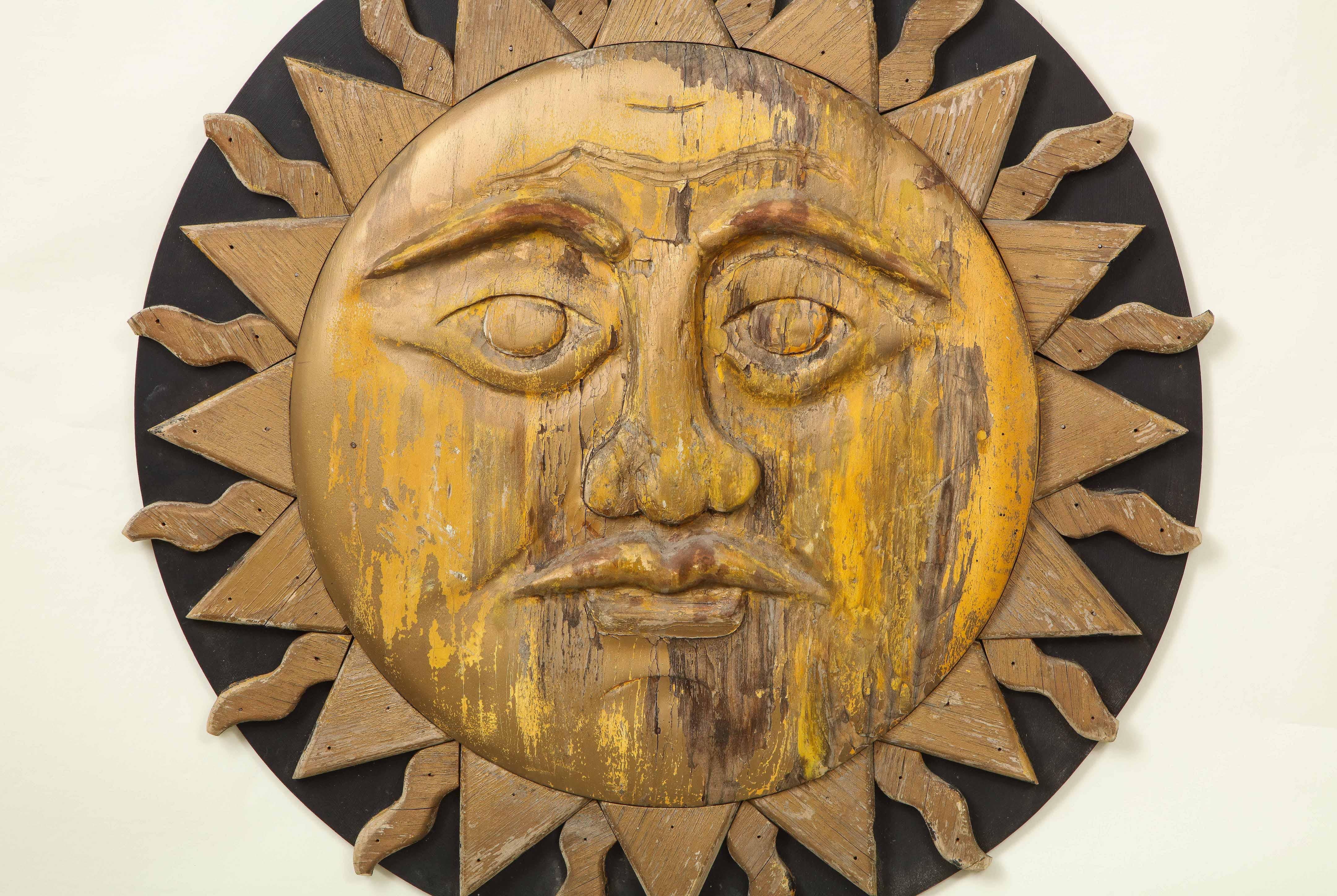 Exuberantly carved sunburst mounted on a black roundel.

Provenance: From the Collection of Mario Buatta, New York, NY.