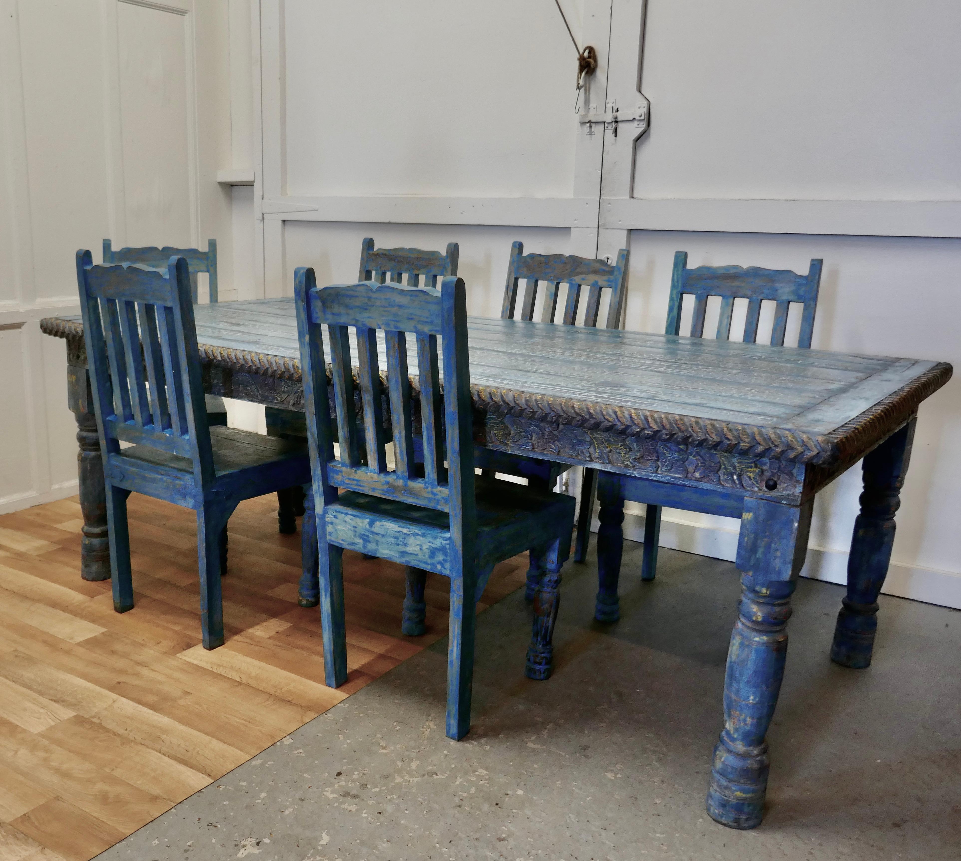 Large carved Folk Art painted table and 6 chairs 

This is a Large, Wide Table it seats 6 or 8 people very comfortably, it has a very unusual crackle painted top 
The table has turned legs and has a carved apron with a rope twist edge around the