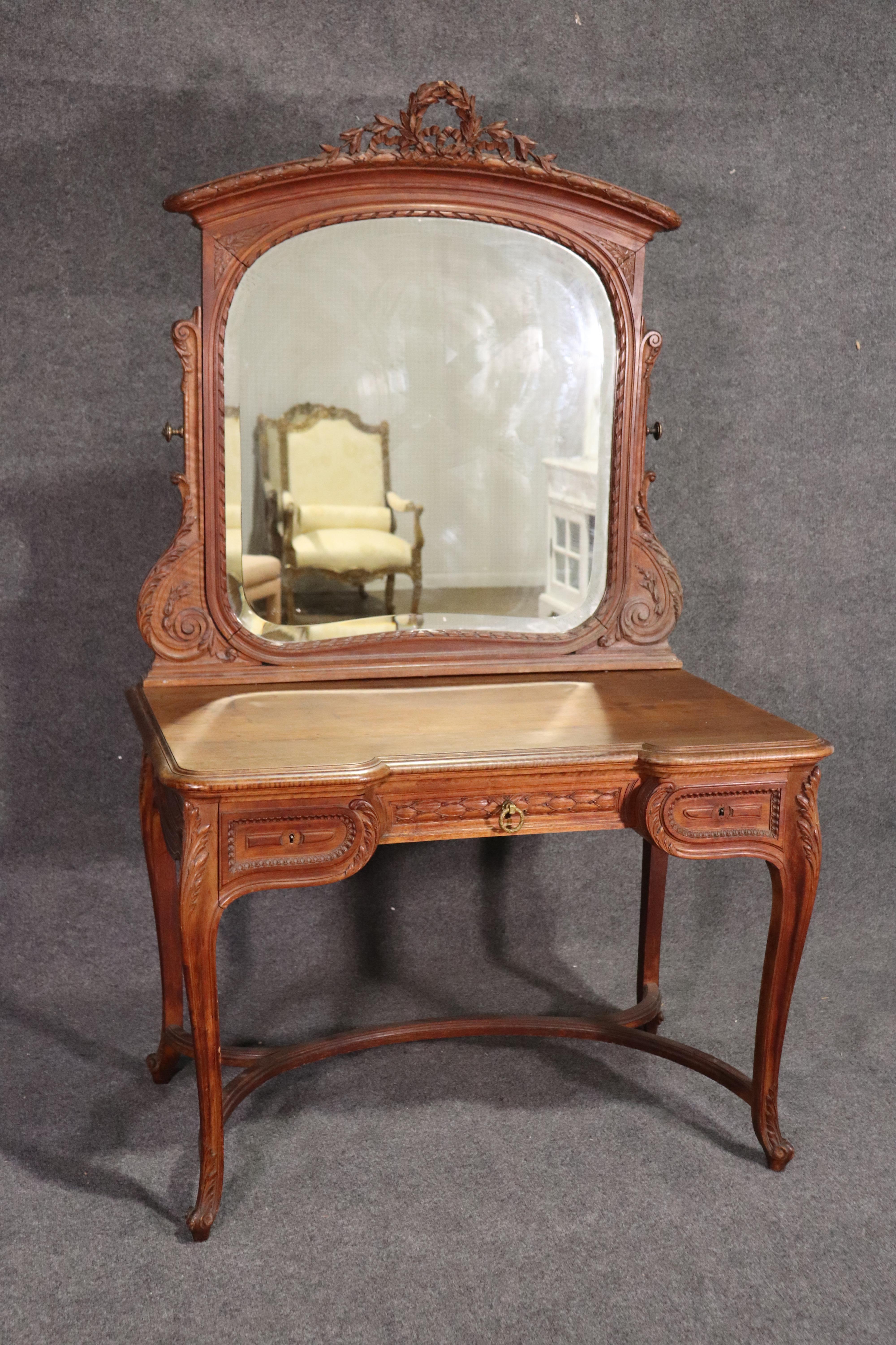 This is a gorgeous carved walnut ladies vanity made in France during the 1920s. It measures 72 tall x 43 wide x 26 deep.