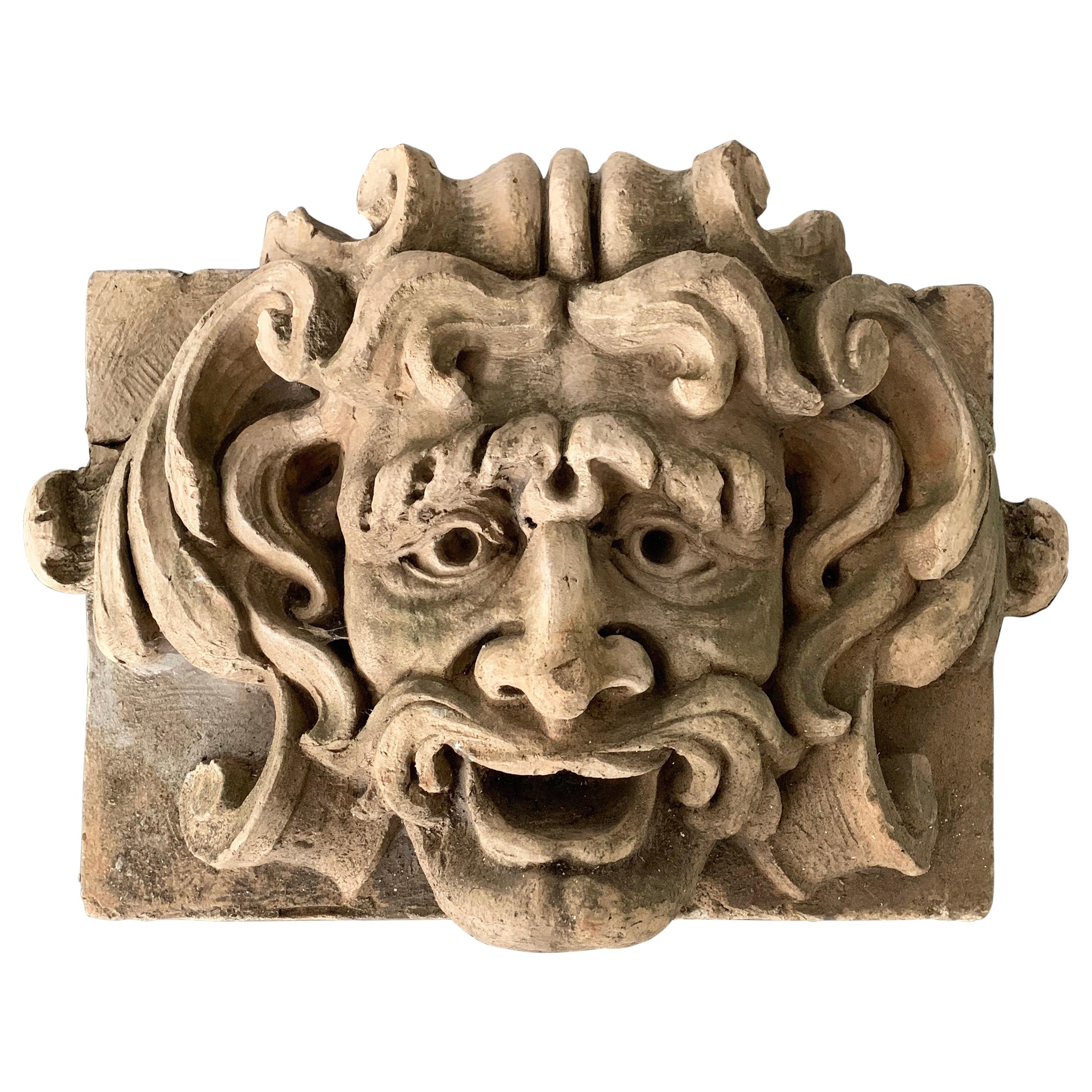 Impressively, large, carved concrete, alto relief depicting an open mouthed, Poseidon-like, gargoyle.
