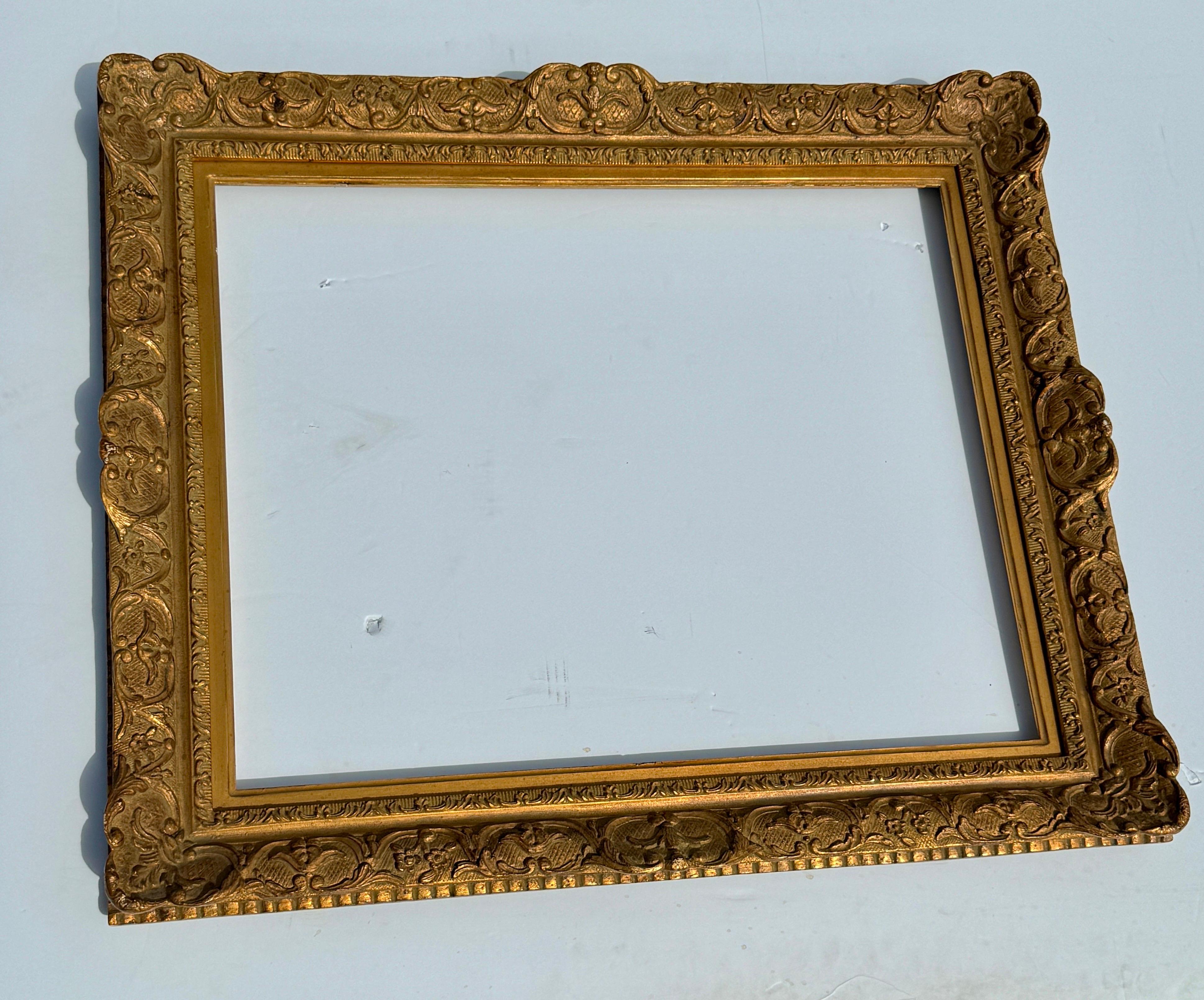 Large Ornate French Rococo Style Carved Ornate Gilt Wood Frame.

This gorgeous hand-crafted frame has lots of charming details including shell motifs and cross hatch features. This substantial piece could be used for a 24inx30in oil painting as well
