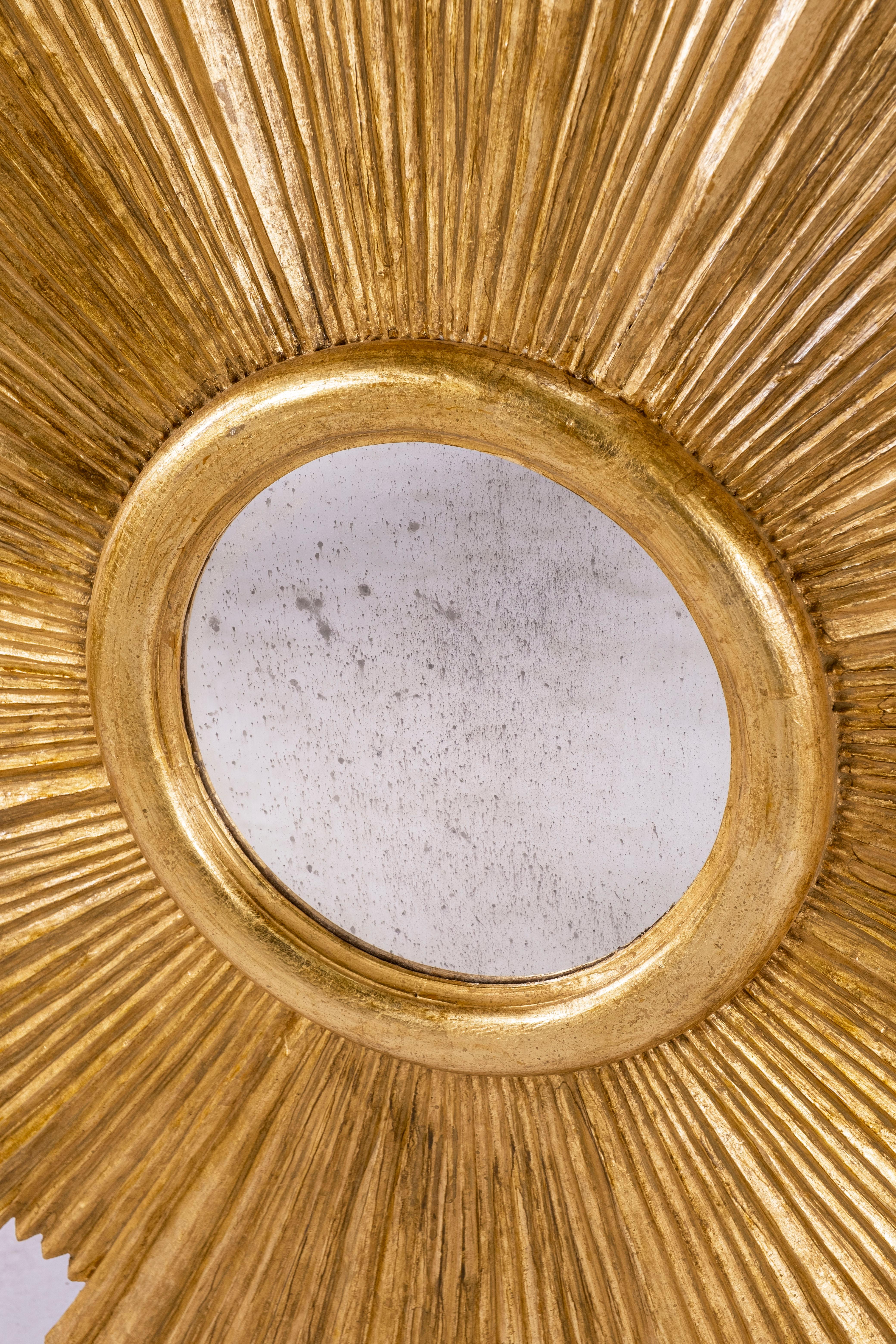 Large carved gilt wood sunburst mirror made in Italy.