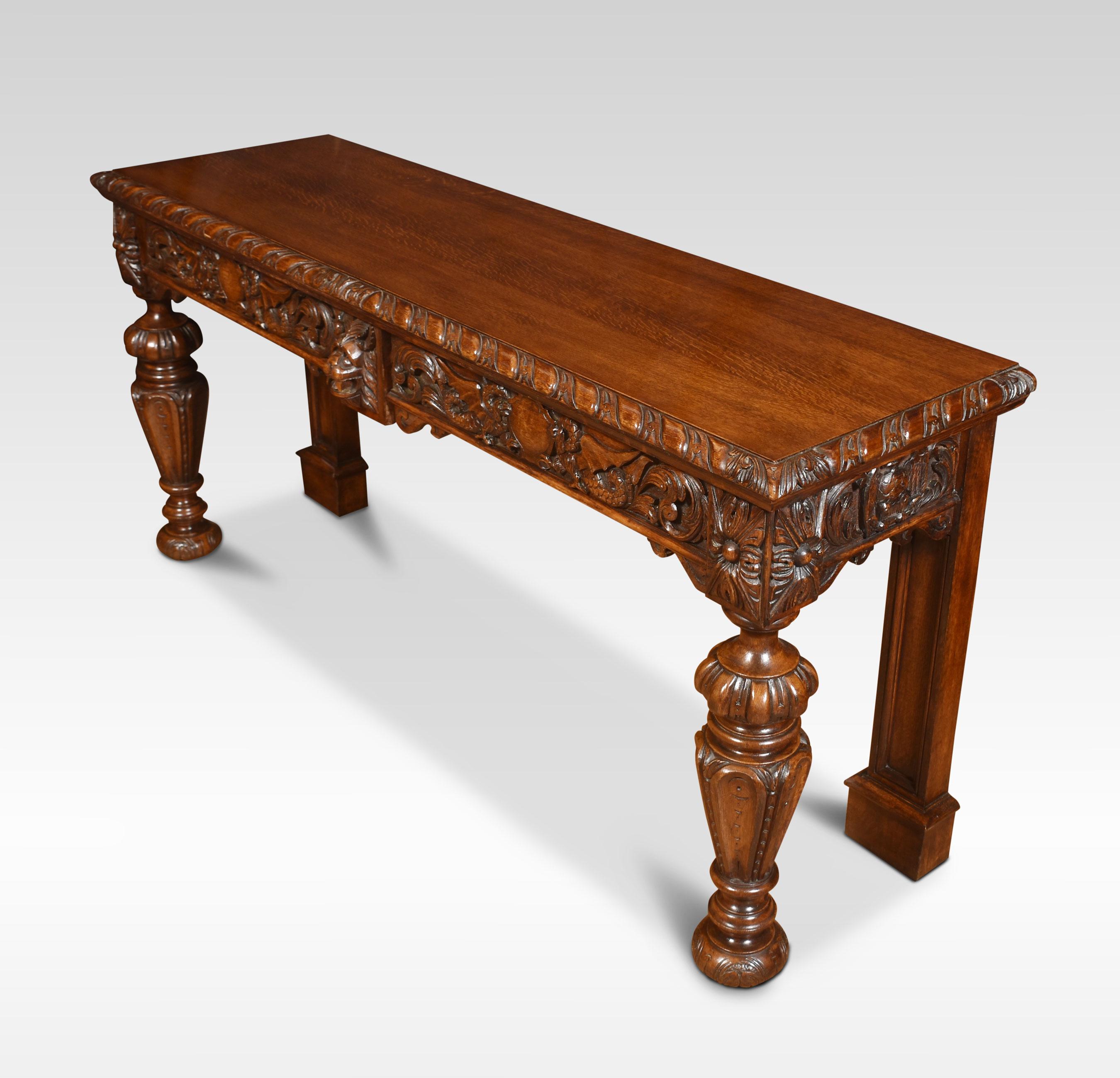 Carved oak console/serving table, the rectangular top with molded edge above two freeze drawers carved with dragons and foliated scrolling relief. All raised up on vase-shaped front supports terminating in carved bun feet.
Dimensions
Height 33.5