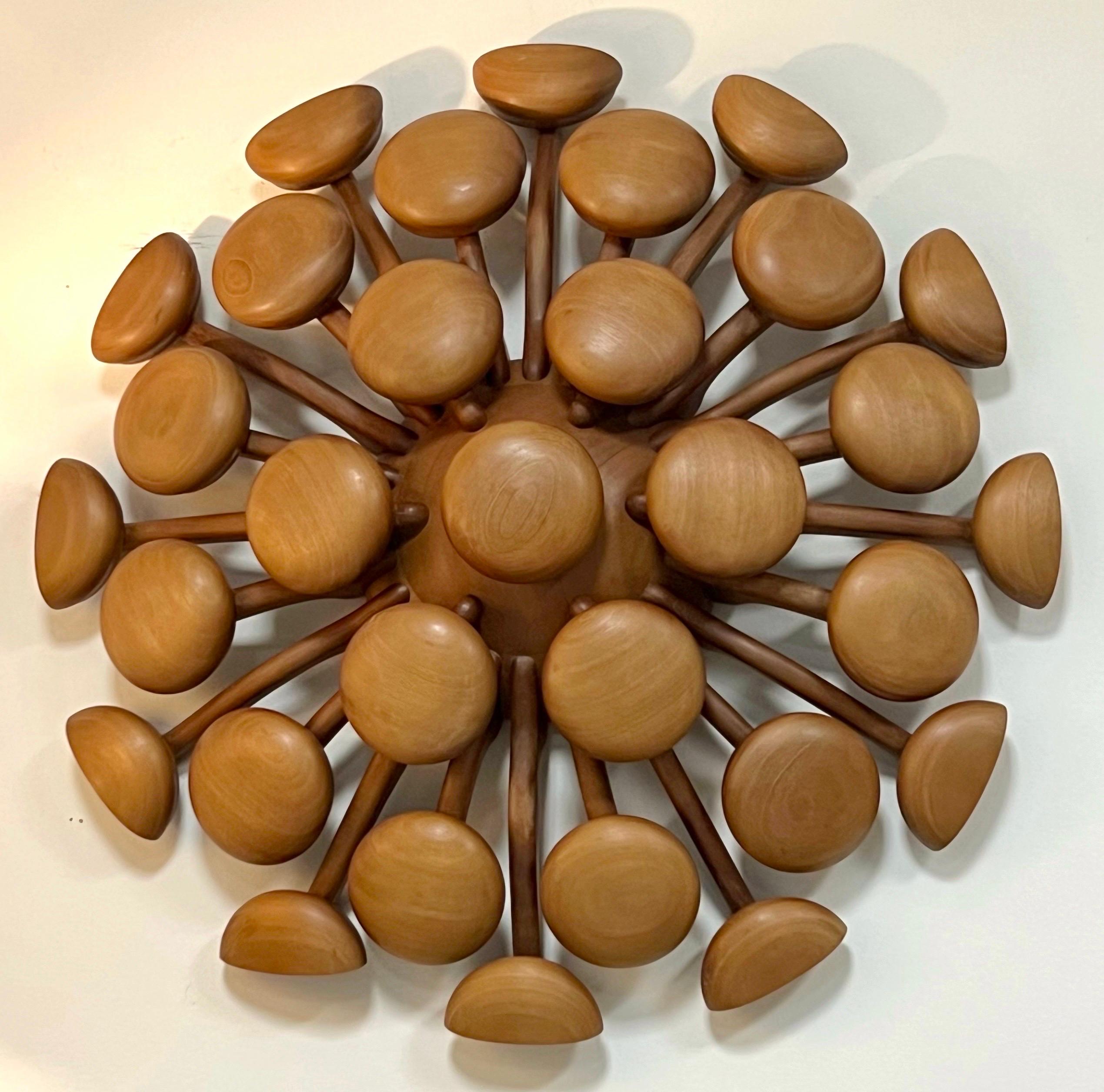 Impressive wall sculpture. A sunburst of sorts, with organic arms holding the round elements. Very high quality craftmanship. Signed and dated by the artist.