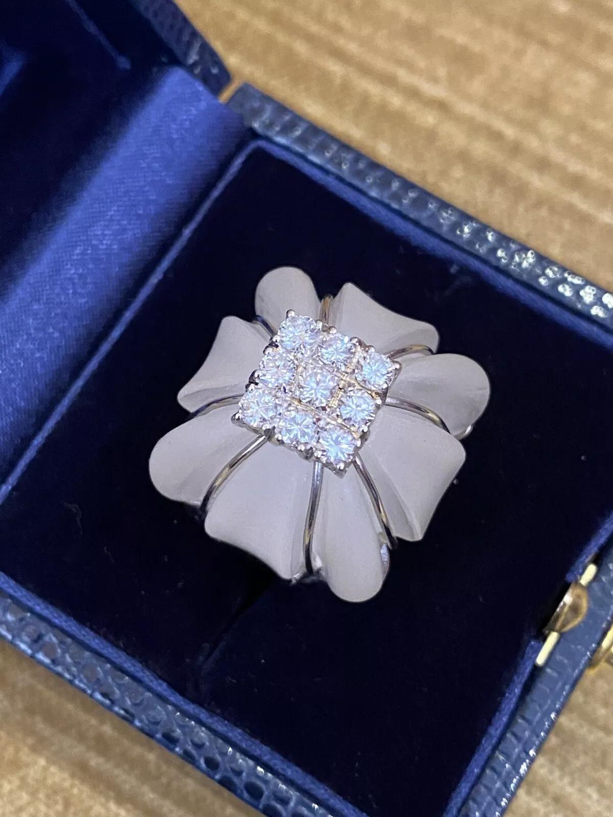 Large Carved Rock Crystal and Diamond Cocktail Ring in 18k White Gold

Carved Rock Crystal and Diamond Ring features one Large Carved Rock Crystal with scalloped edges topped with 9 Round Brilliant Diamonds weighing 1.00 carat, all set in 18k White