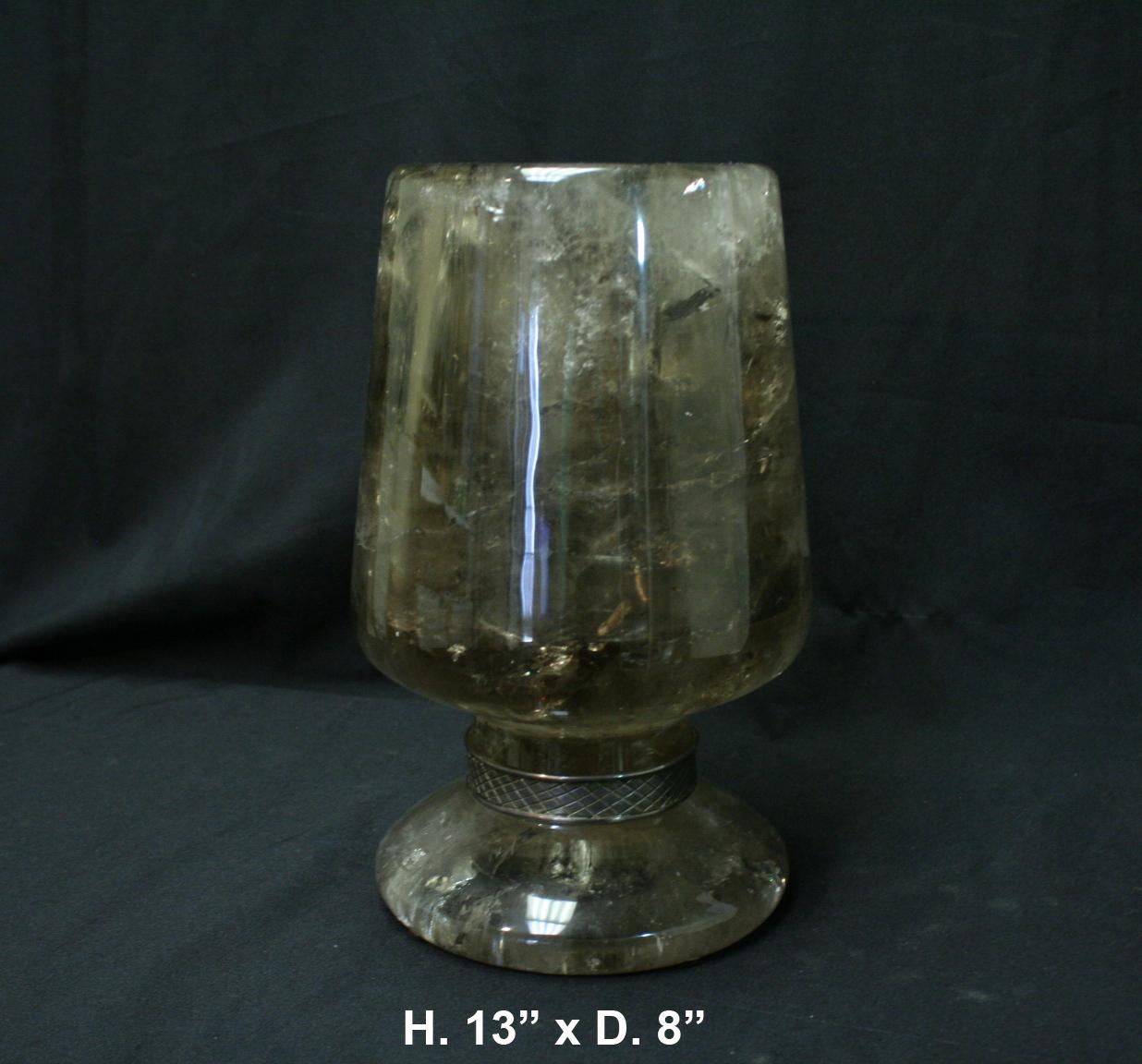 Spectacular one of a kind large hand carved and hand polished smokey rock crystal urn. 
With decorated brass band around the neck.
This urn can be used as an outstanding centerpiece with flowers. It is very sturdy and heavy.

Free shipping in