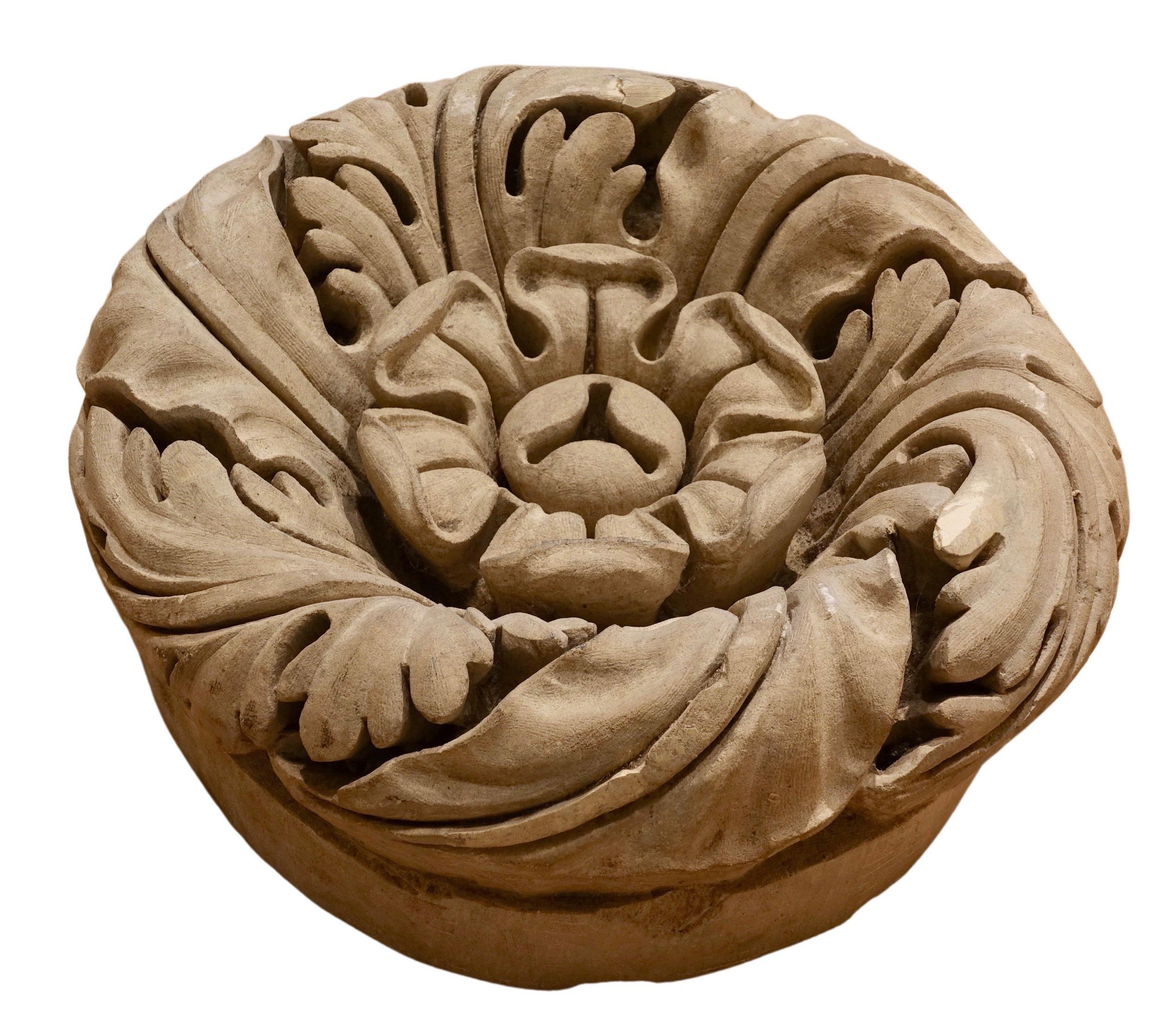 Large carved stone rosette
France, 18th century
Diameter: 29.5 cm

This carved rosette likely adorned a ceiling. This rounded vault key exhibits a delicately crafted decor, with deeply carved piercings. This virtuoso work adeptly plays with light