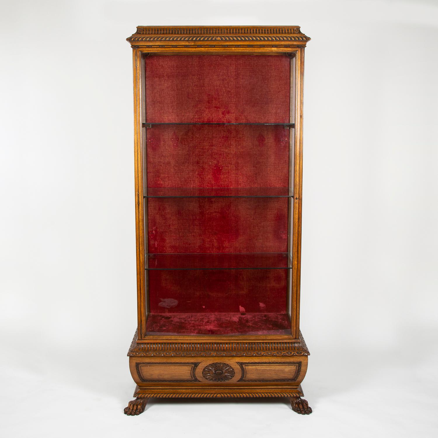 A large carved walnut display case, velvet lined, with three glass shelves, and two internal lights, English, circa 1910.