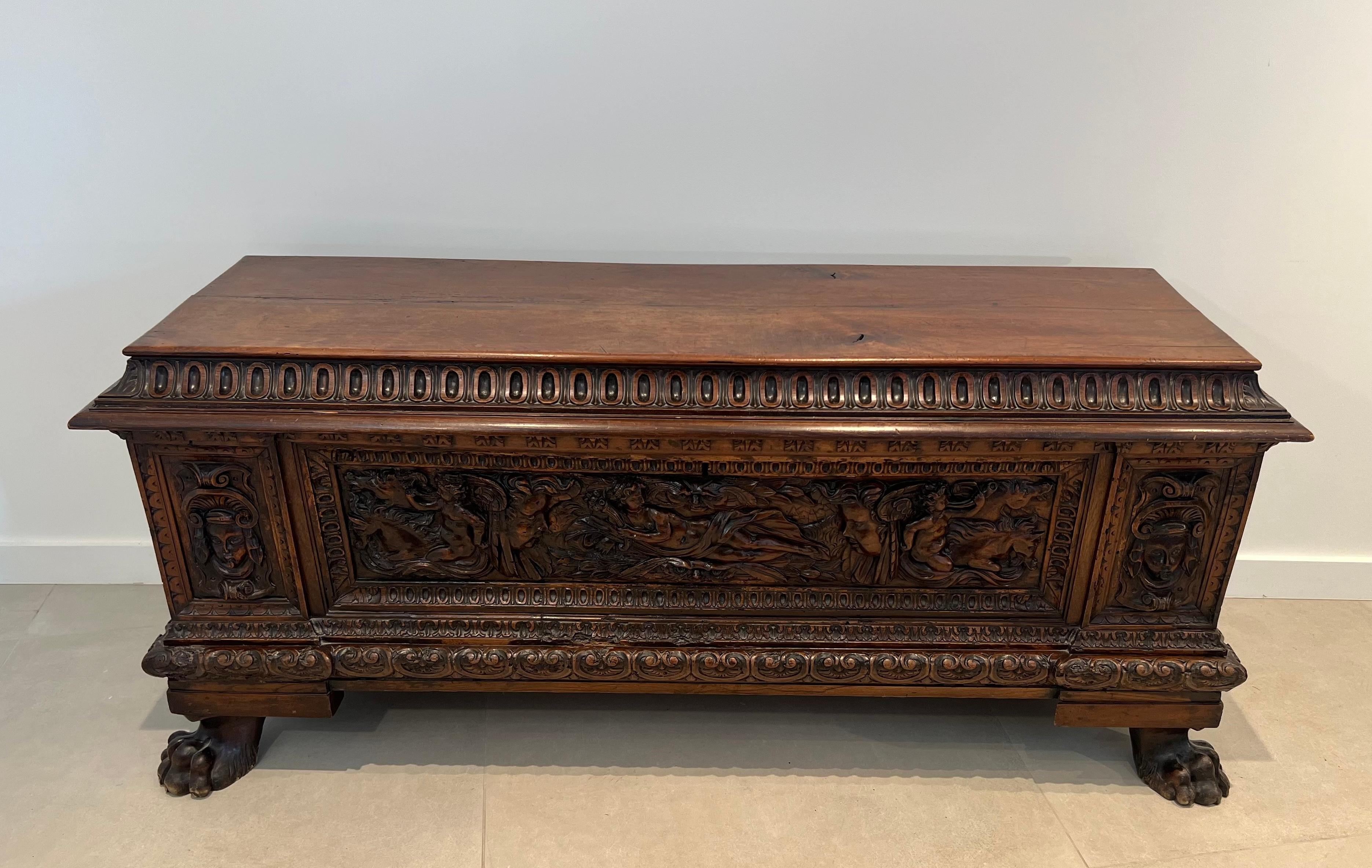 This very nice large cassone chest resting on four claw feet is made of walnut. The piece is richly carved with faces, cherubs and horse seenes. This is an Italian piece from Renaissance period. 17th century