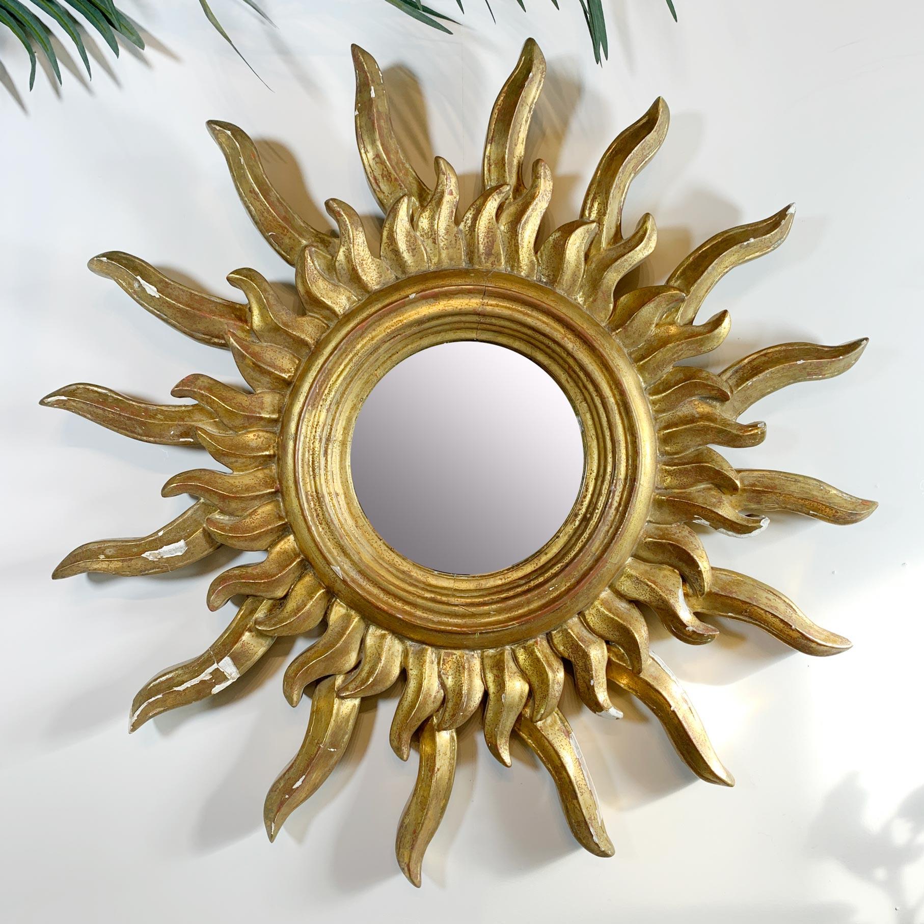 An incredible and very large-scale gilt gesso over carved hardwood Sunburst Mirror, French, dating to the 1920’s.

This is an impressively substantial, heavy mirror, there are areas of loss to the gilt and gesso, and the mirror is a vintage