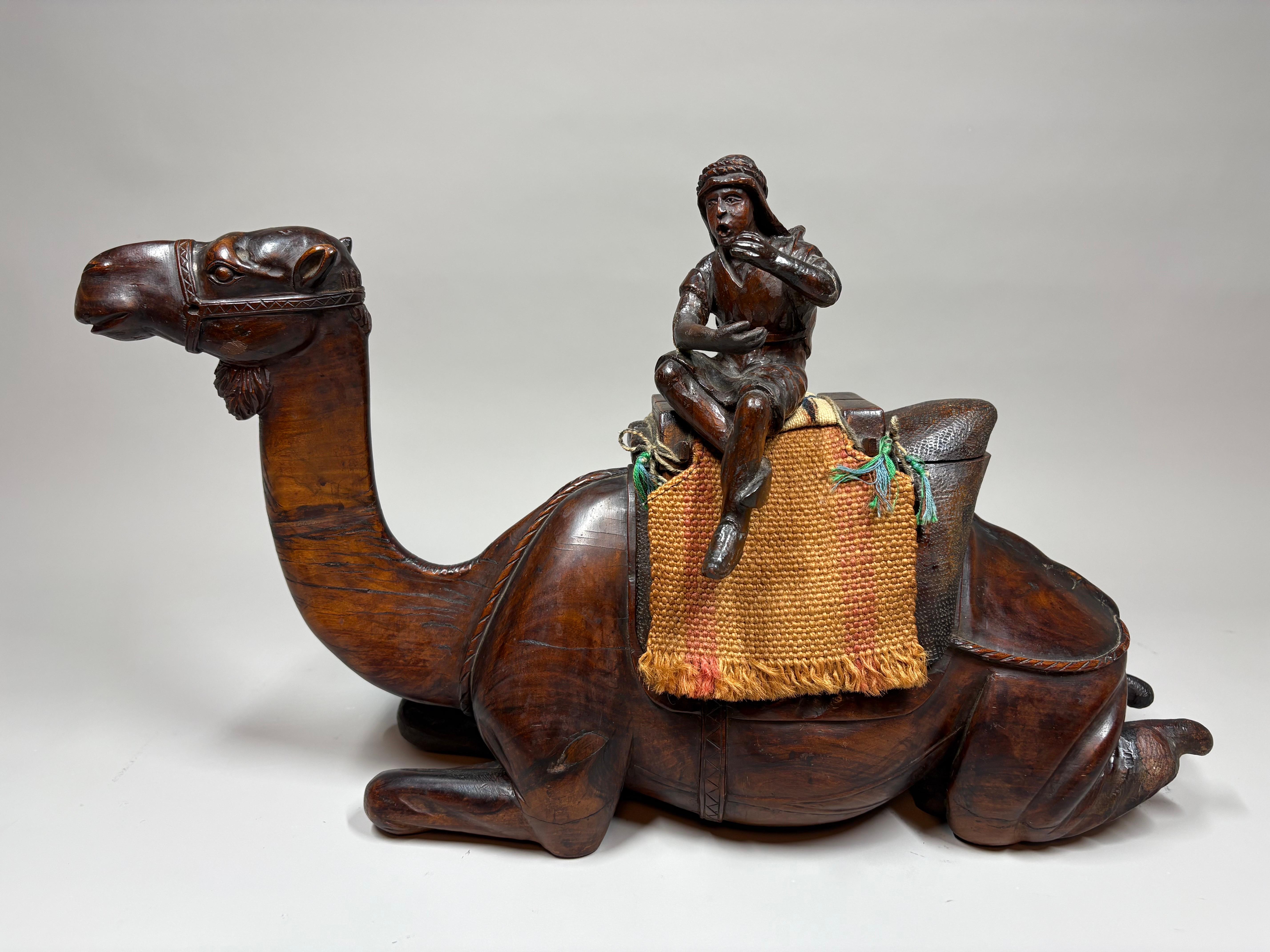 A large and unusual early 20th-century Austrian Orientalist hand-carved wooden novelty box and cover, modeled as a reclining camel with a seated rider atop its hump.

Orientalism was immensely popular in early 20th-century Vienna, inspiring