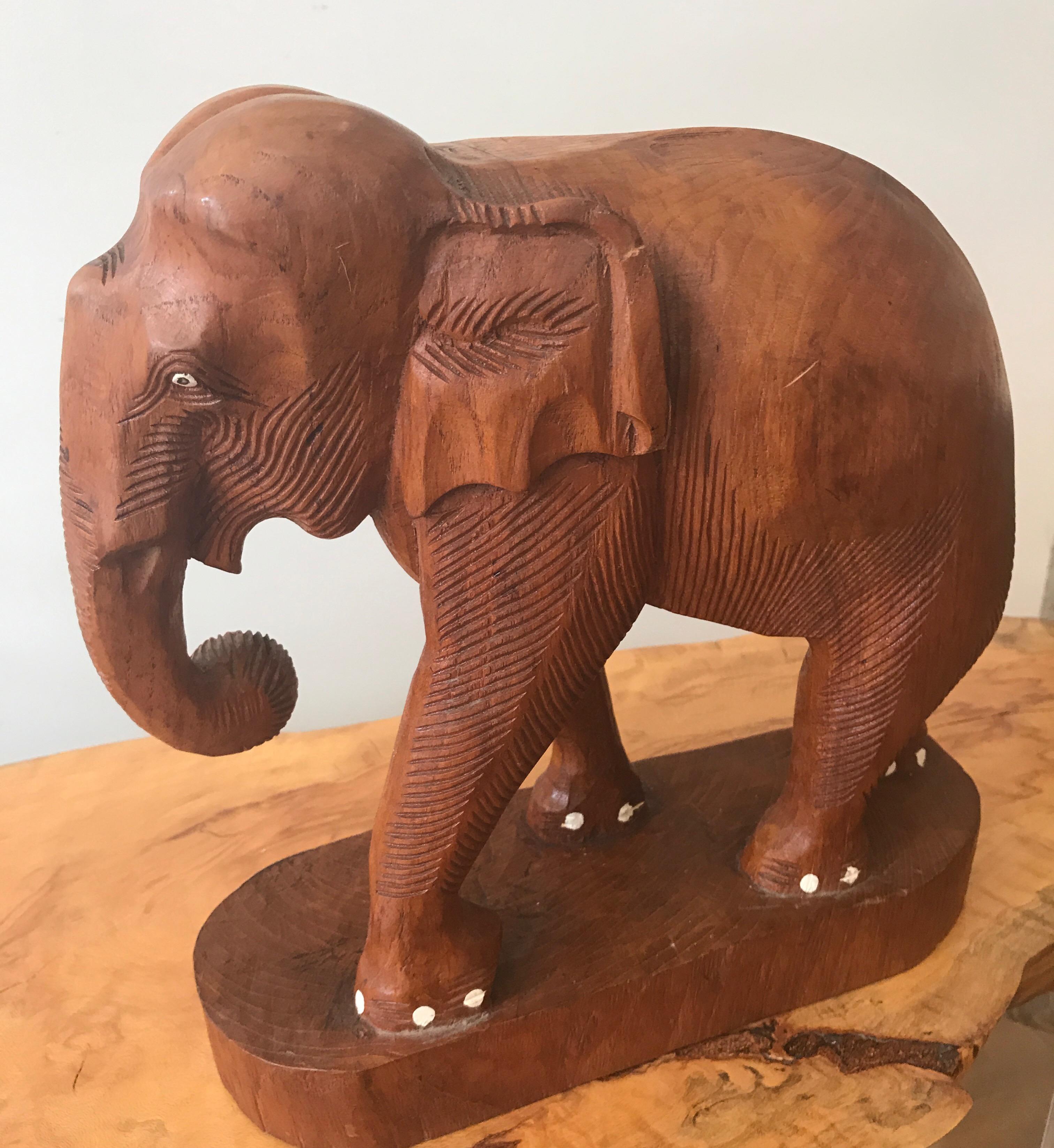 Large finely carved Indian wood sculpture of an Elephant.
The exotic pachyderm has painted toenails
and appears to have had tusks at one time.
Exceptional table top decorative object.

    