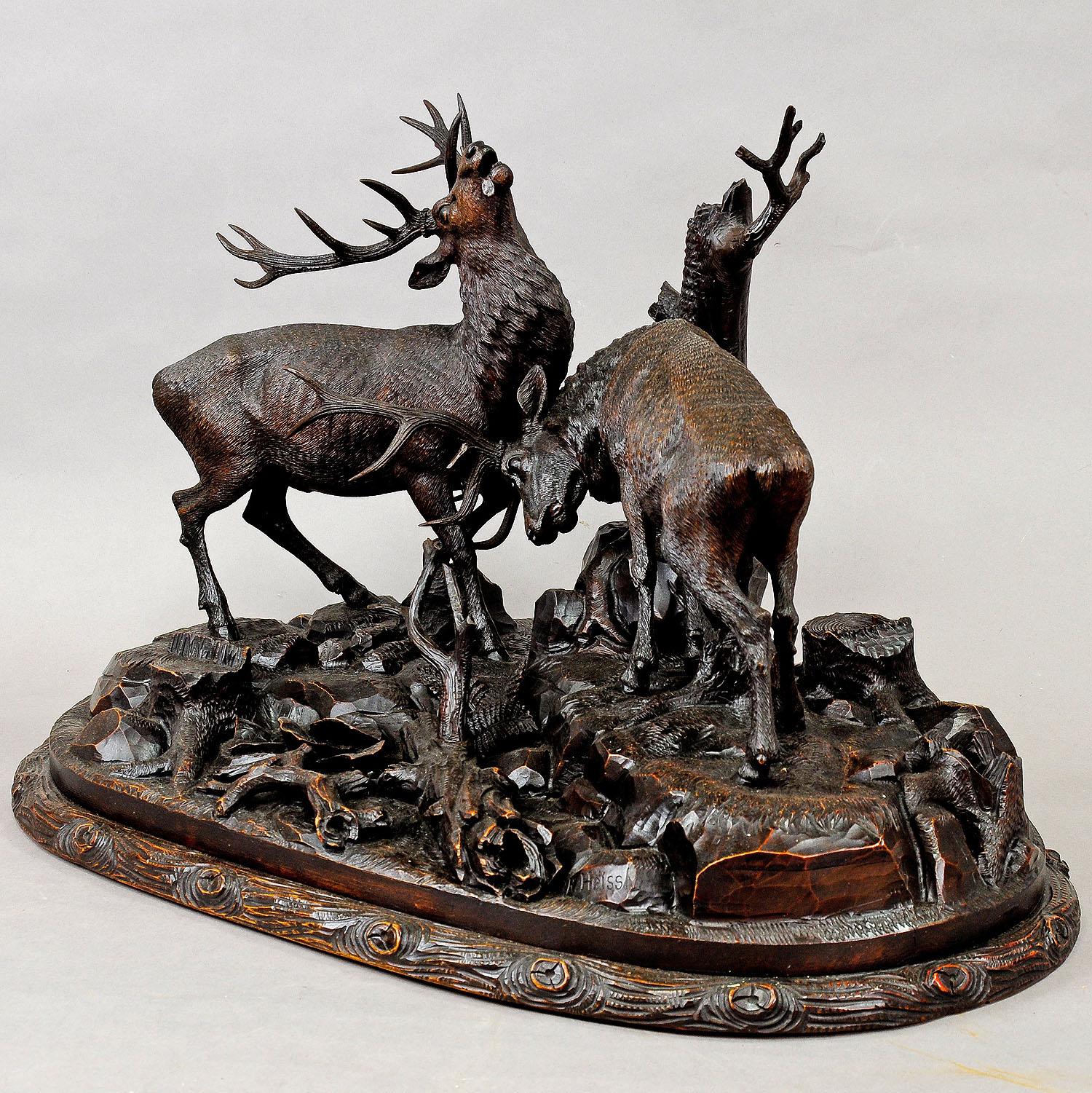 Large Carved Wood Fighting Stags by Rudolph Heissl

An extremely rare, grandiose handcarved wood sculpture. The two fighting stags are on a rocky base with three stumps.  A very detailed natural carving by the Austrian woodcarver Rudolph Heissl