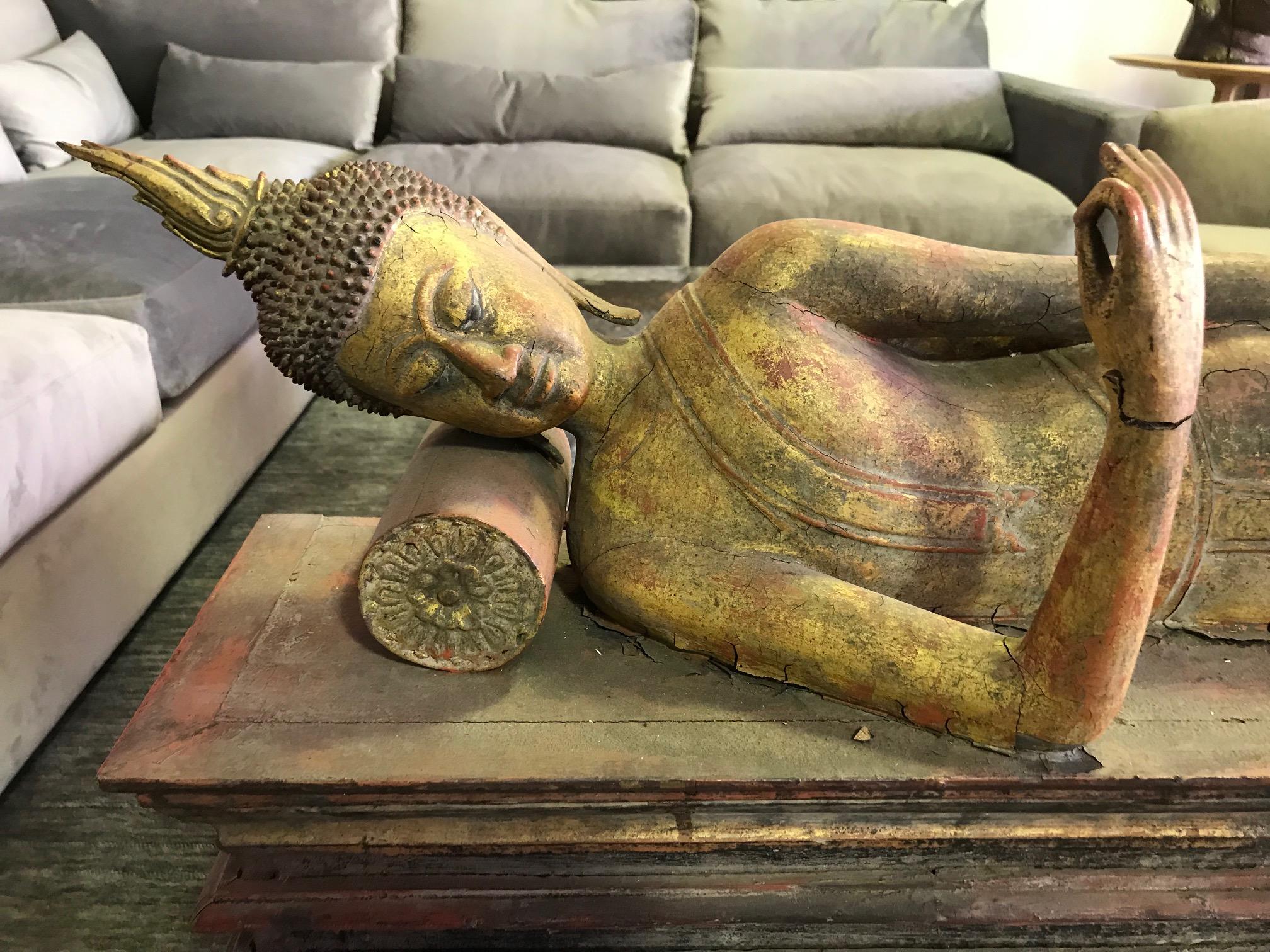 Large hand carved wood, gilt and lacquer reclining Buddha on stand. Likely Northern Thai. Beautifully carved and detailed and relatively rare in this position. 

Great addition to any collection or eye-catching accent piece to any setting.