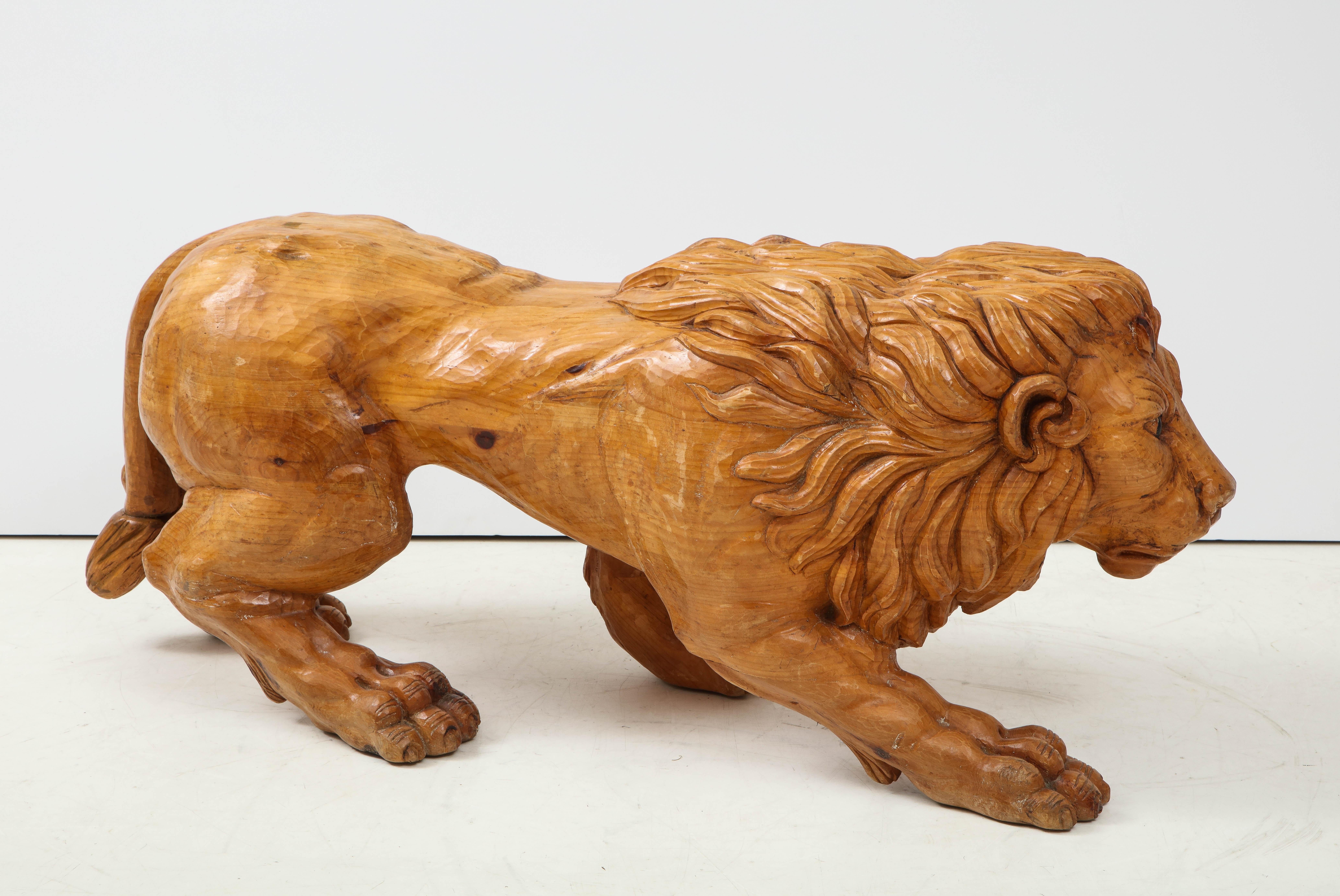 Large scale sculptural hand carved wood, prowling lion bench. A great room addition as sculpture, bench or coffee table base.