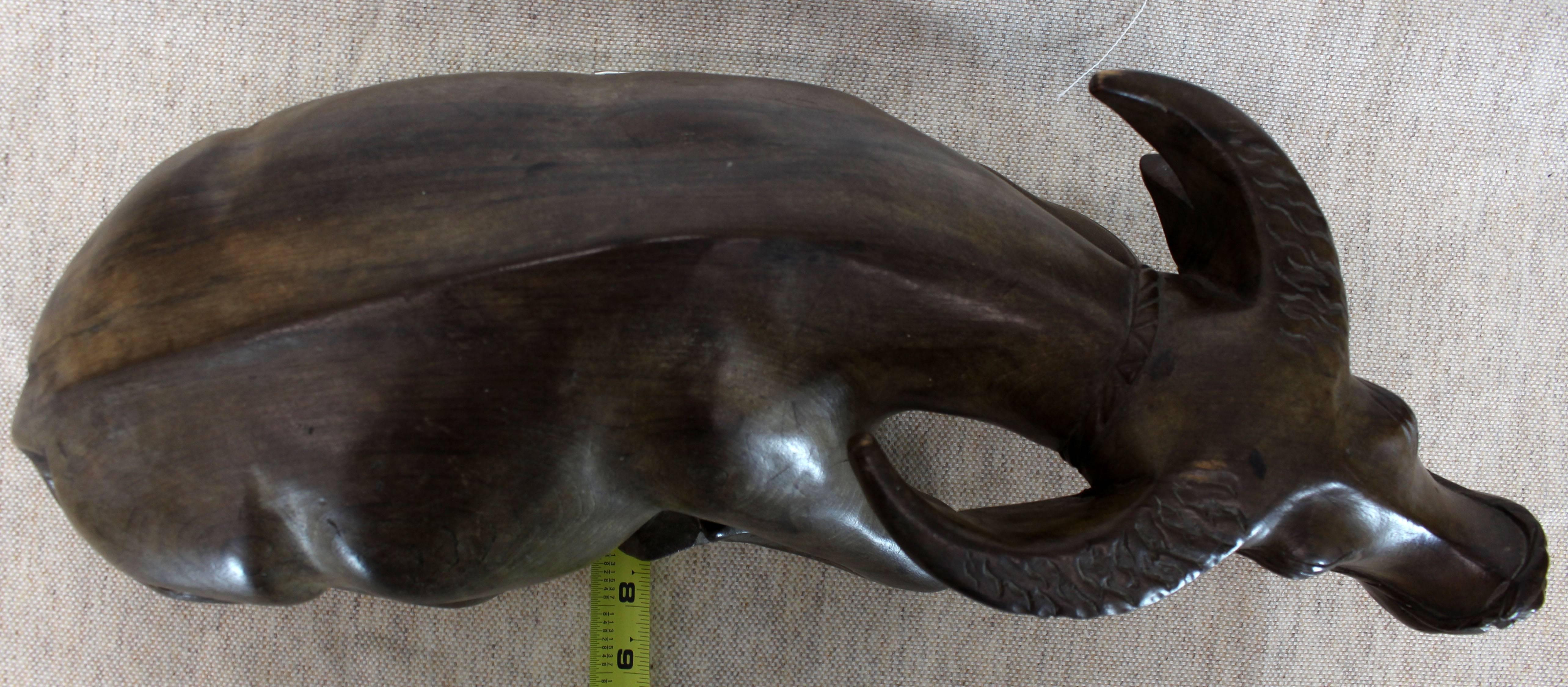 Nice patina, large, fine carved sculpture of water buffalo. The wood seems to be black walnut.