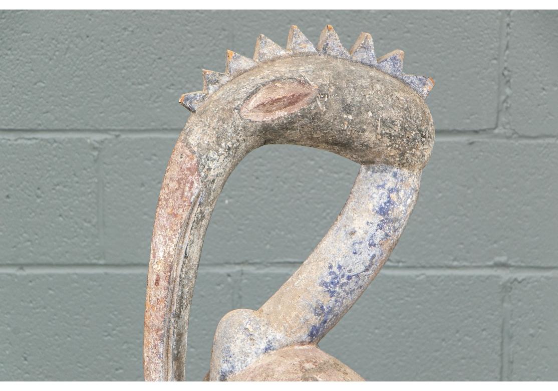 A large and powerful carving attributed to the Senoufo Tribe of West Africa. The Sculpture represents an adult Hornbill with ridged crest and upright stance standing guard over it’s much smaller young. Strongly carved and with an old distressed