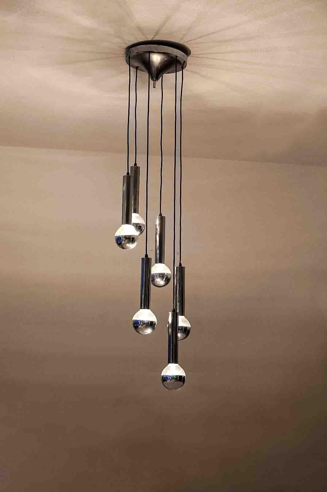 Impressive mid-century modern cascading ceiling chandelier featuring six extra large half-mirrored bulbs. This lamp is fully adorned in chrome and in very good condition.
