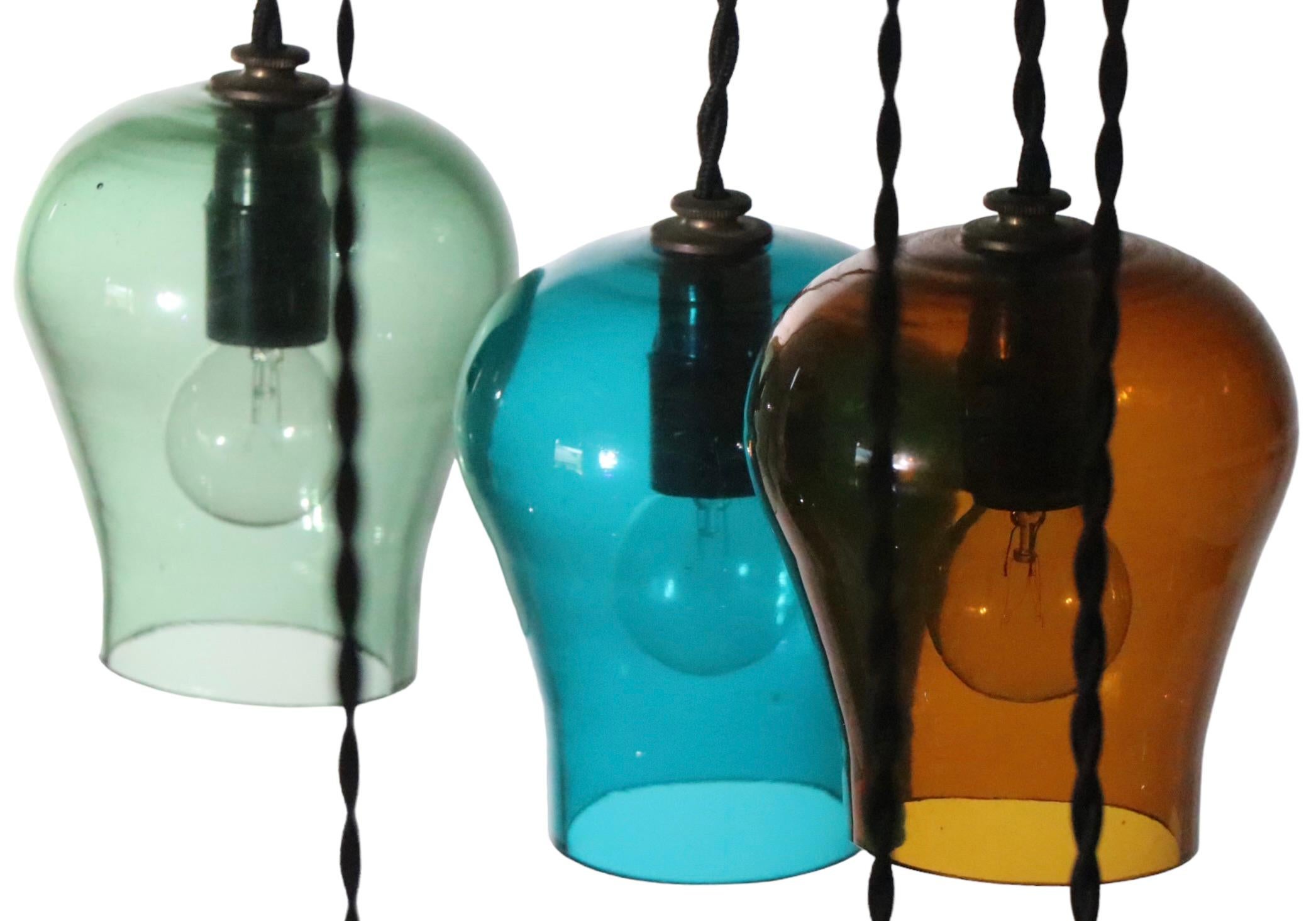 20th Century  Large Cascading 12 Light  Mid Century Chandelier with Colored Glass Bell Shades For Sale