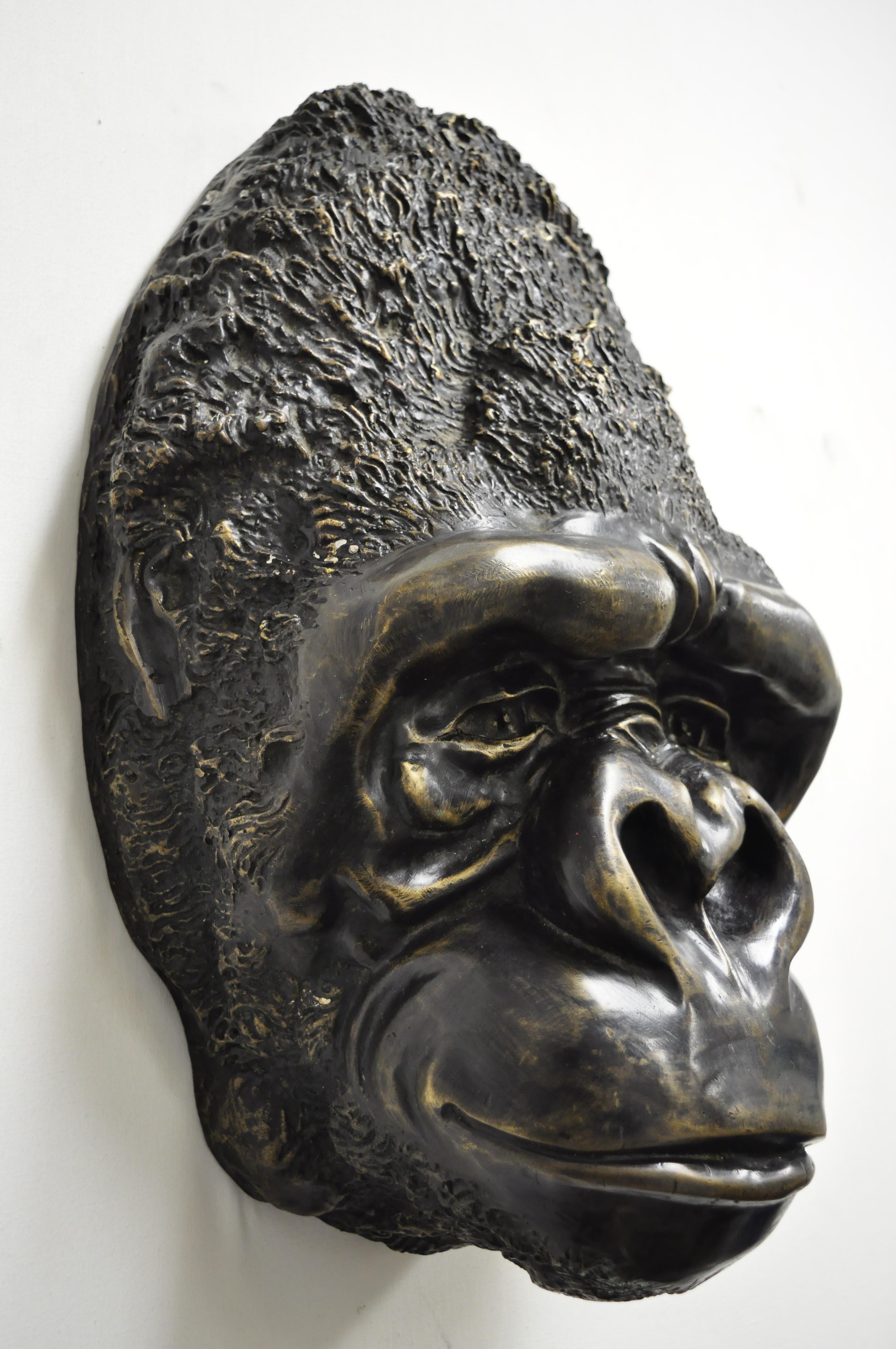 Large and impressive cast bronze gorilla head wall sculpture for a Taxidermy Collector (B). Item features heavy cast bronze construction, remarkable life-like details, large impressive size, holes to rear to hang on wall, weighs approximately 22lbs,