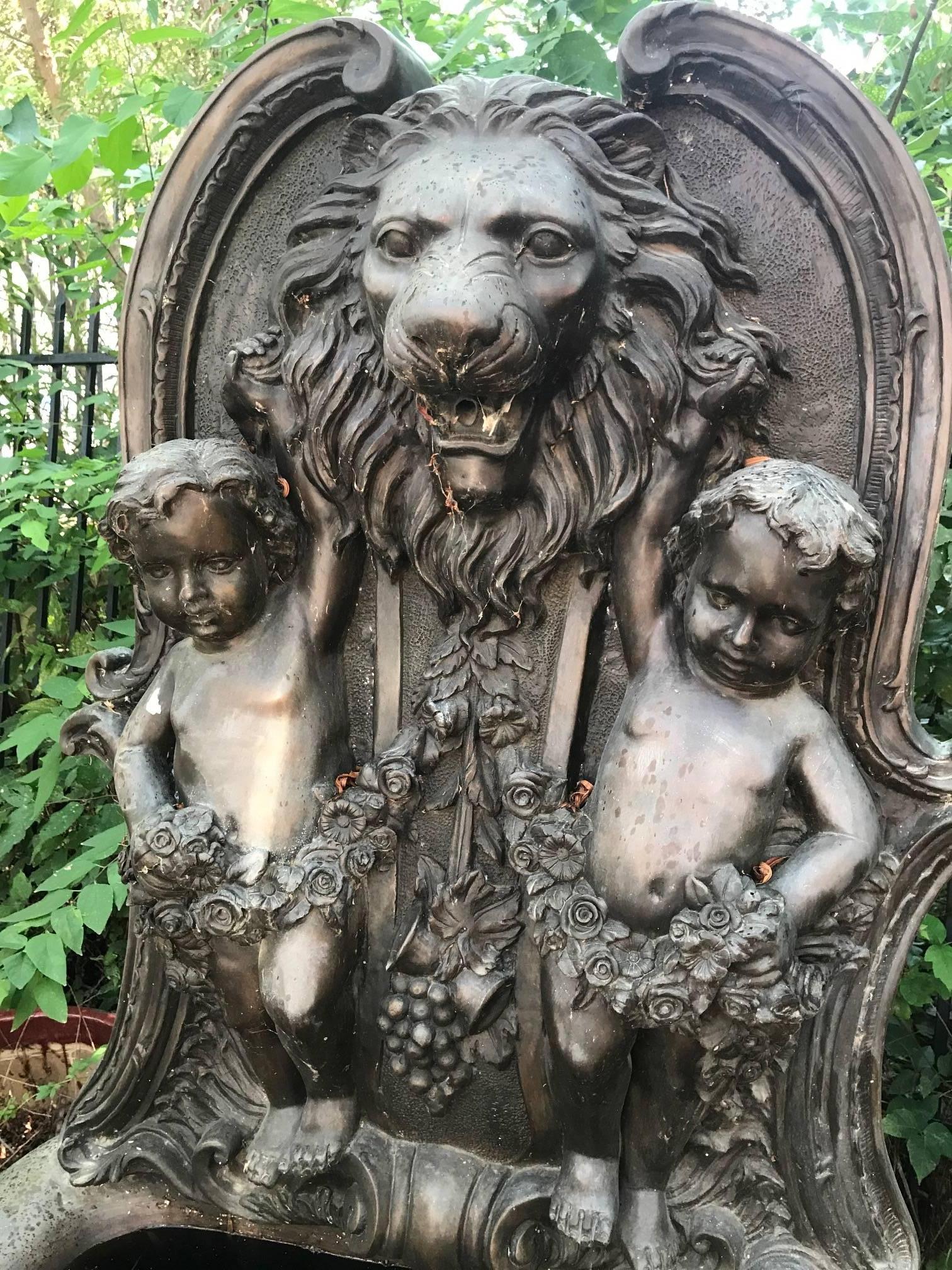 Magnificent and large English cast bronze garden fountain. The top with a finely detailed lion's masque flanked by cherubs holding festoon swags.

The basin supported by a three dolphin bronze base. Wonderful weathered appearance.

 