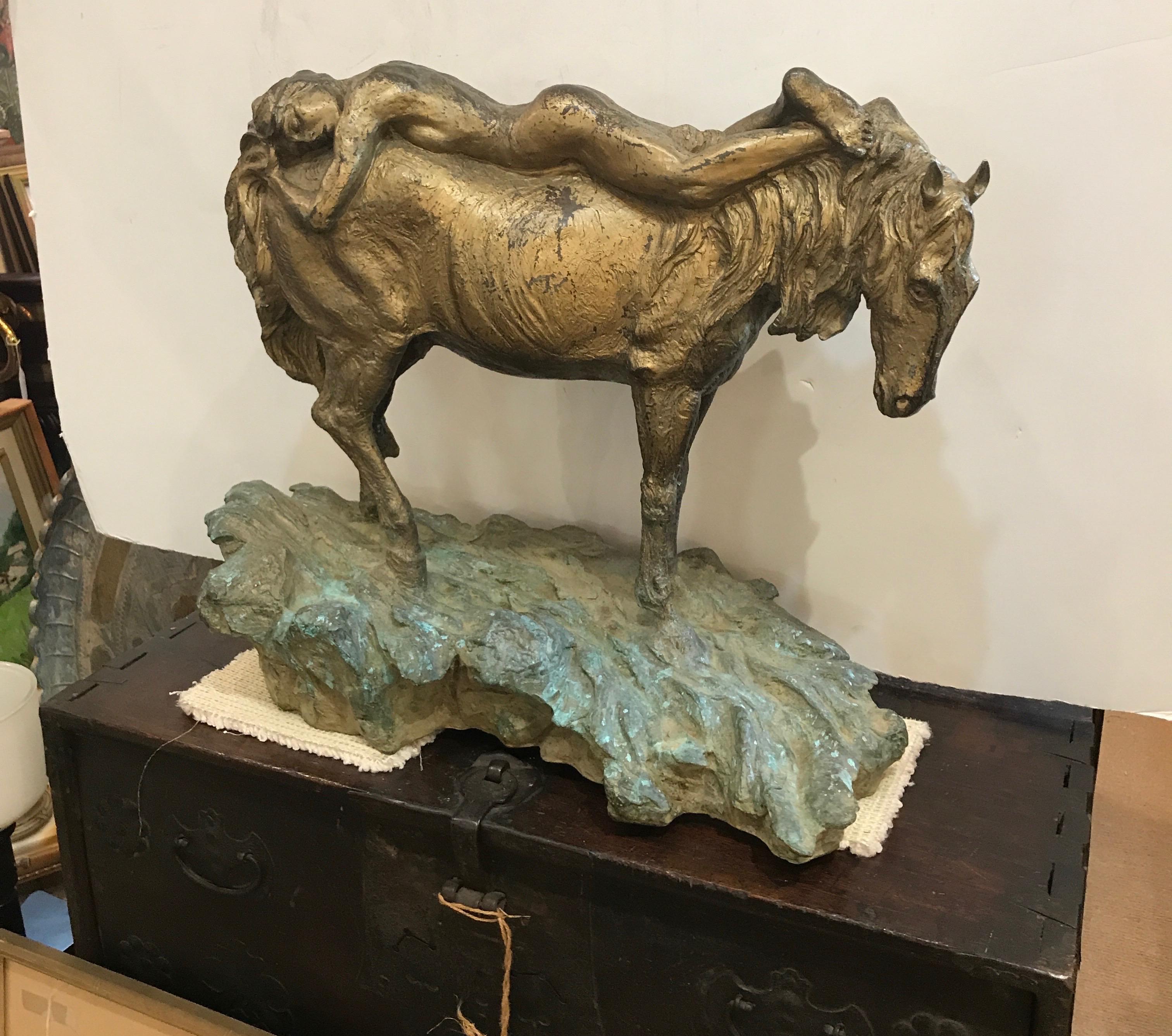 The heavy bronze sculpture with a horse with a reclining female nude rider. The surface is a weathered gilt and Verdi green finish. Artist signed on the lower back, C. Ragvan 11/30 The sculpture with a impressionist effect, 25 inches wide, 20 inches