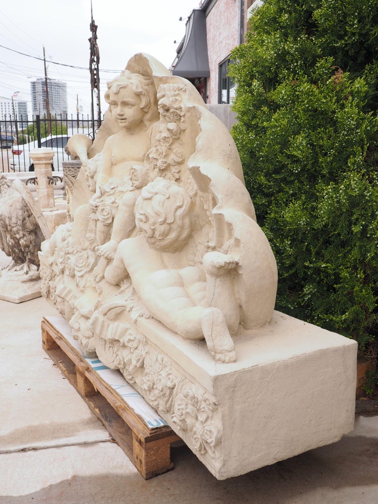 Large Cast Garden Statue of Putti with Flowers, Shell, and Mascaron In Good Condition In Dallas, TX