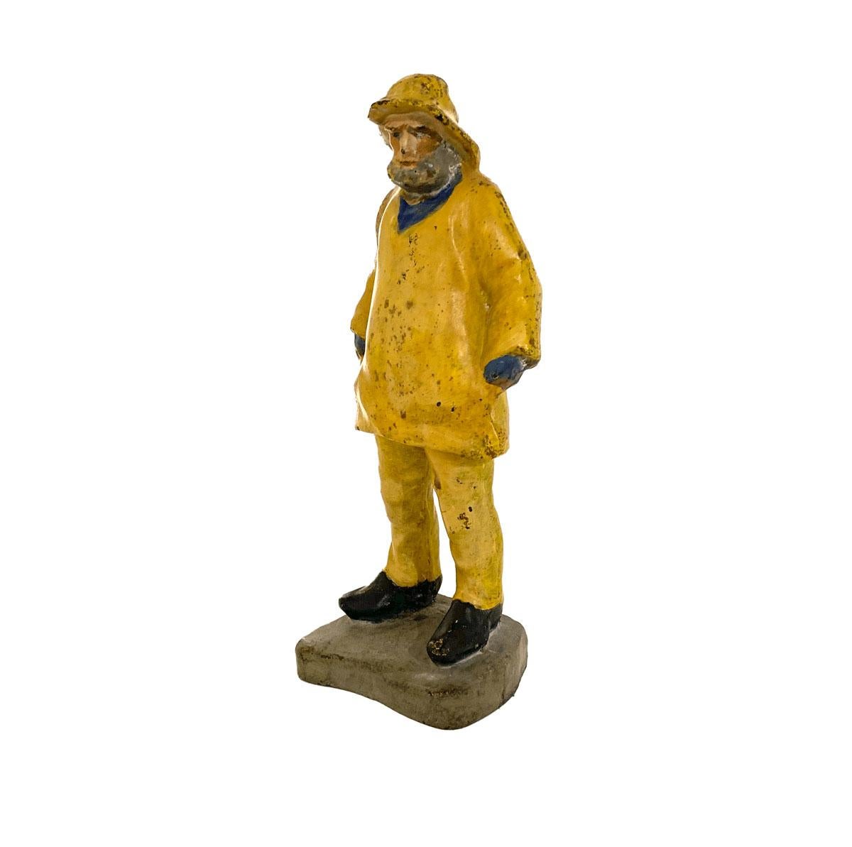 Large cast iron doorstop in the form of and old salt sailor / fisherman with a grey beard and wearing yellow foul weather gear. Manufactured by the Eastern Specialty Manufacturing Company of Connecticut and marked 