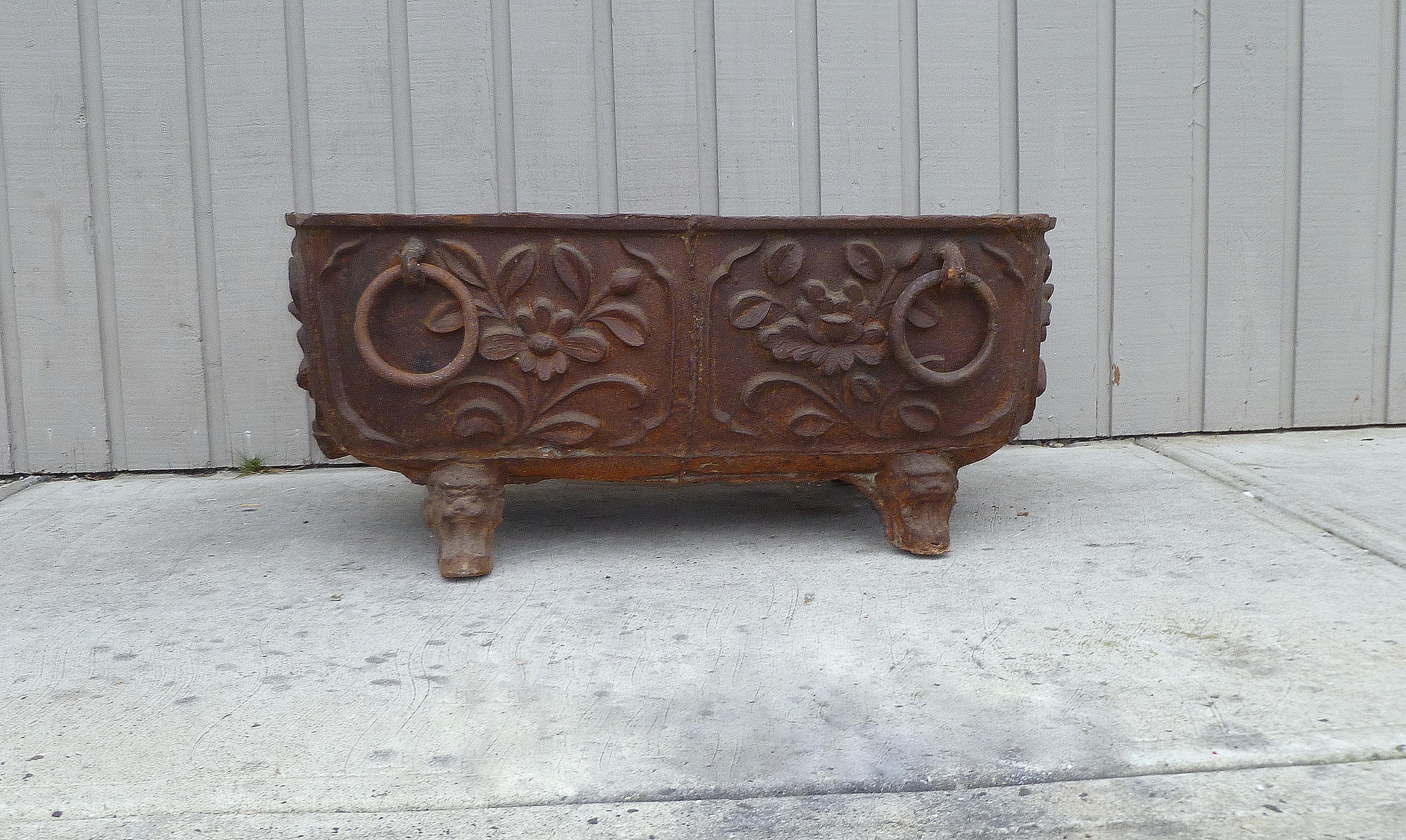 Large cast iron tub with floral motif with four ring pulls, there is one casted inscription on one side with date made : 